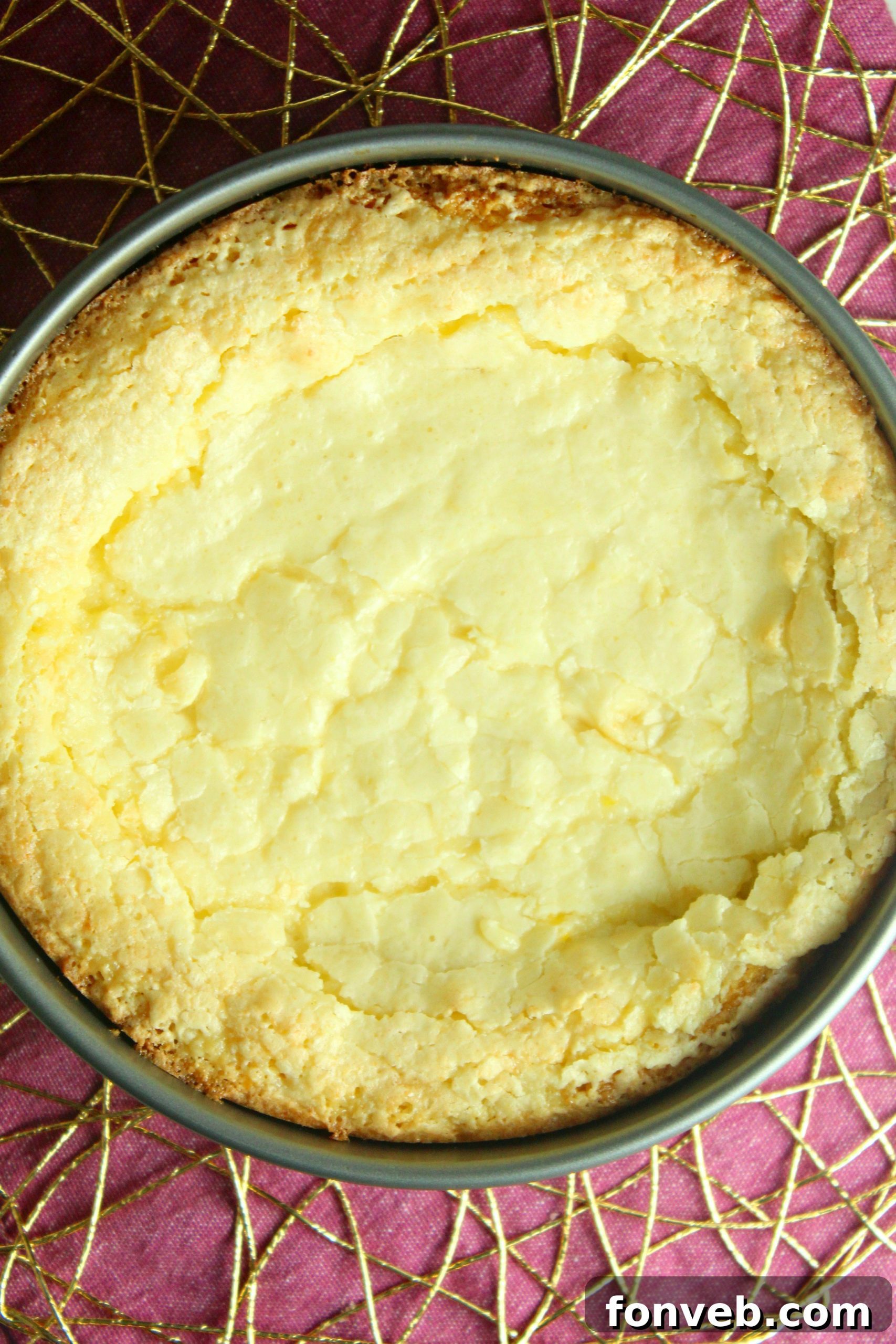 A close-up of a serving of Ooey Gooey Butter Cake, showing its appealing texture.