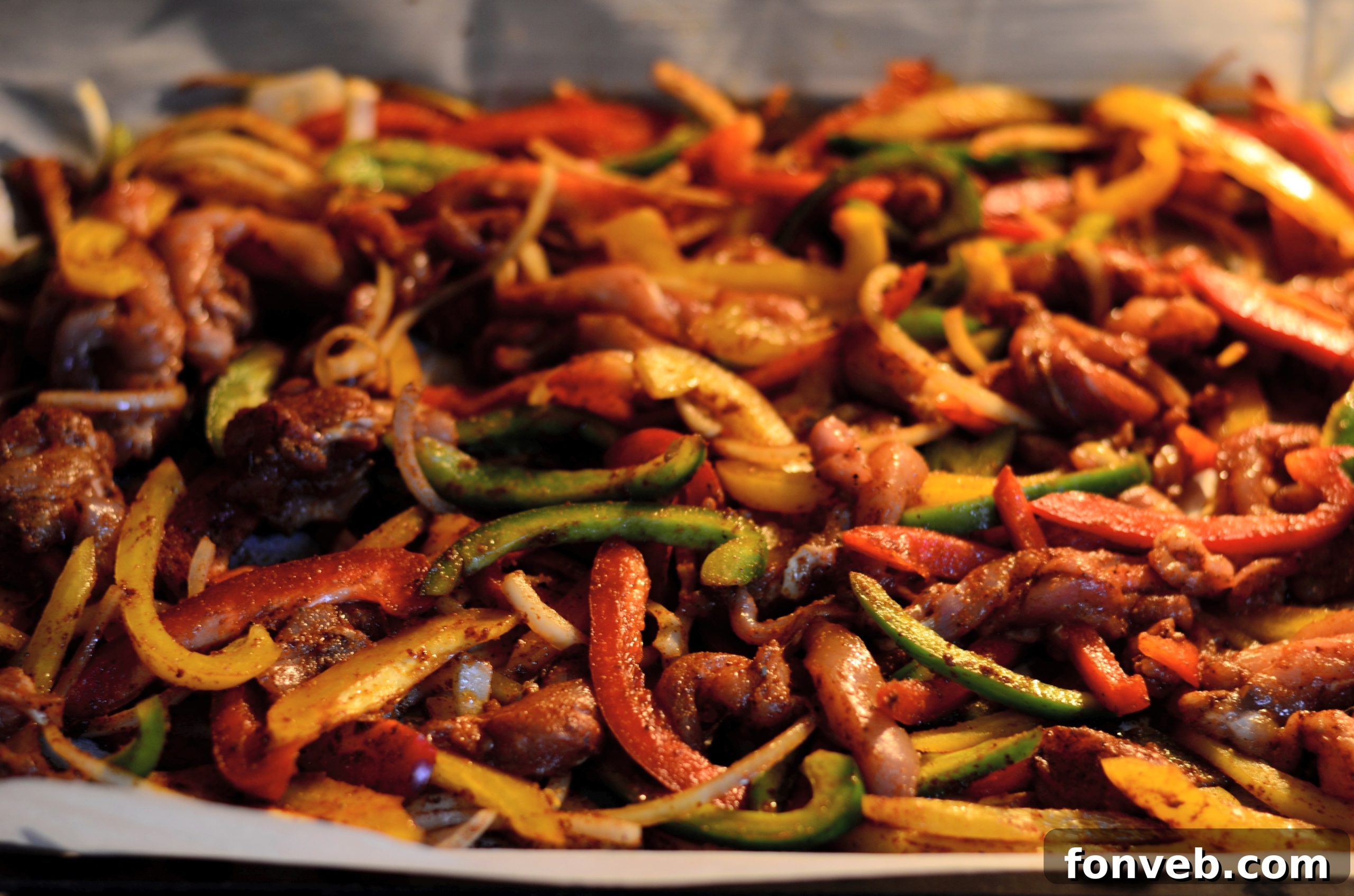 Sheet Pan Chicken Fajitas with fresh lime and cilantro garnishes, ready to be served.