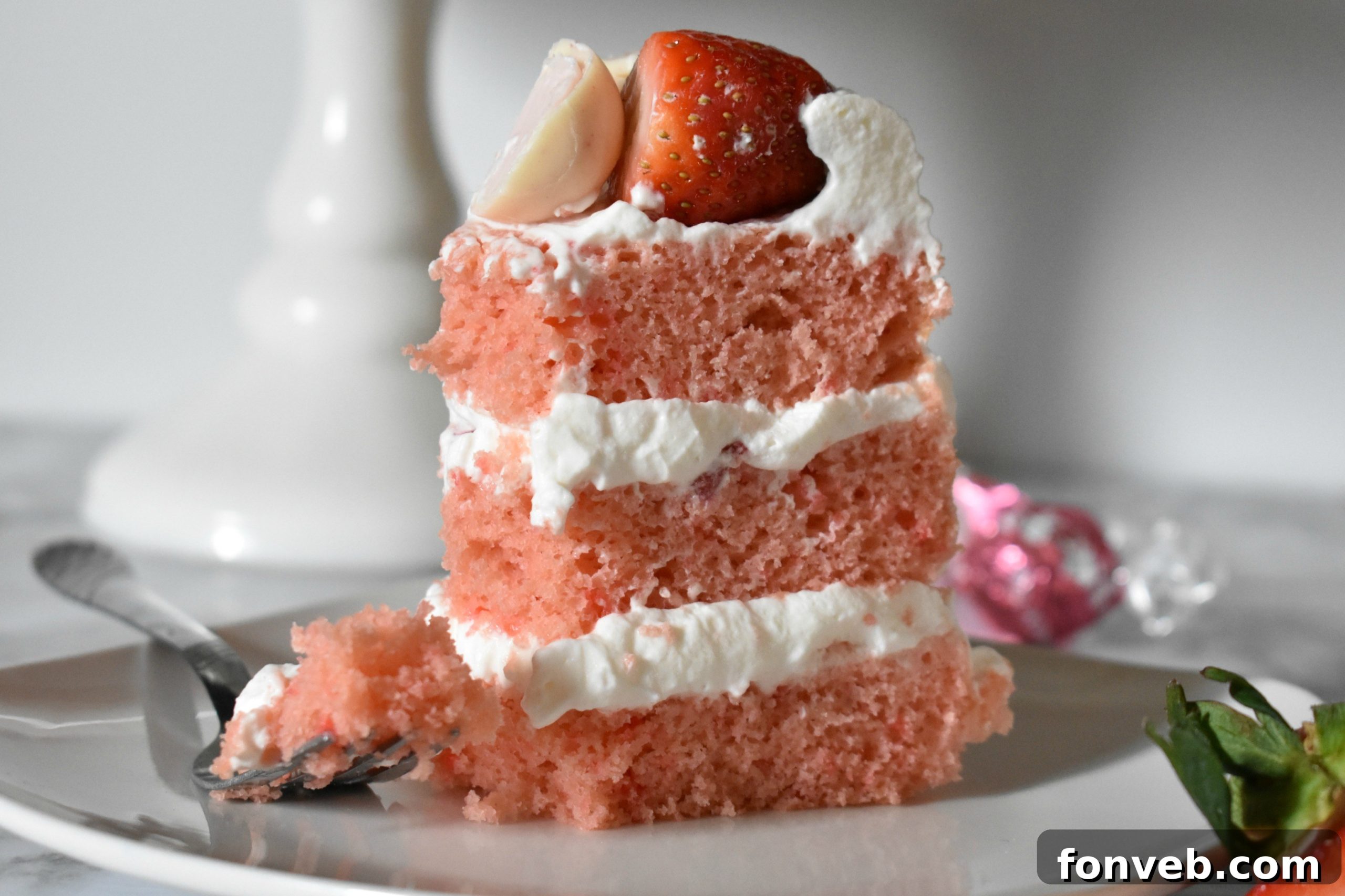 Strawberry Creamsicle Dream Cake 7 Close-up of Strawberry Creamsicle Layered Cake with fresh strawberry slices and white frosting