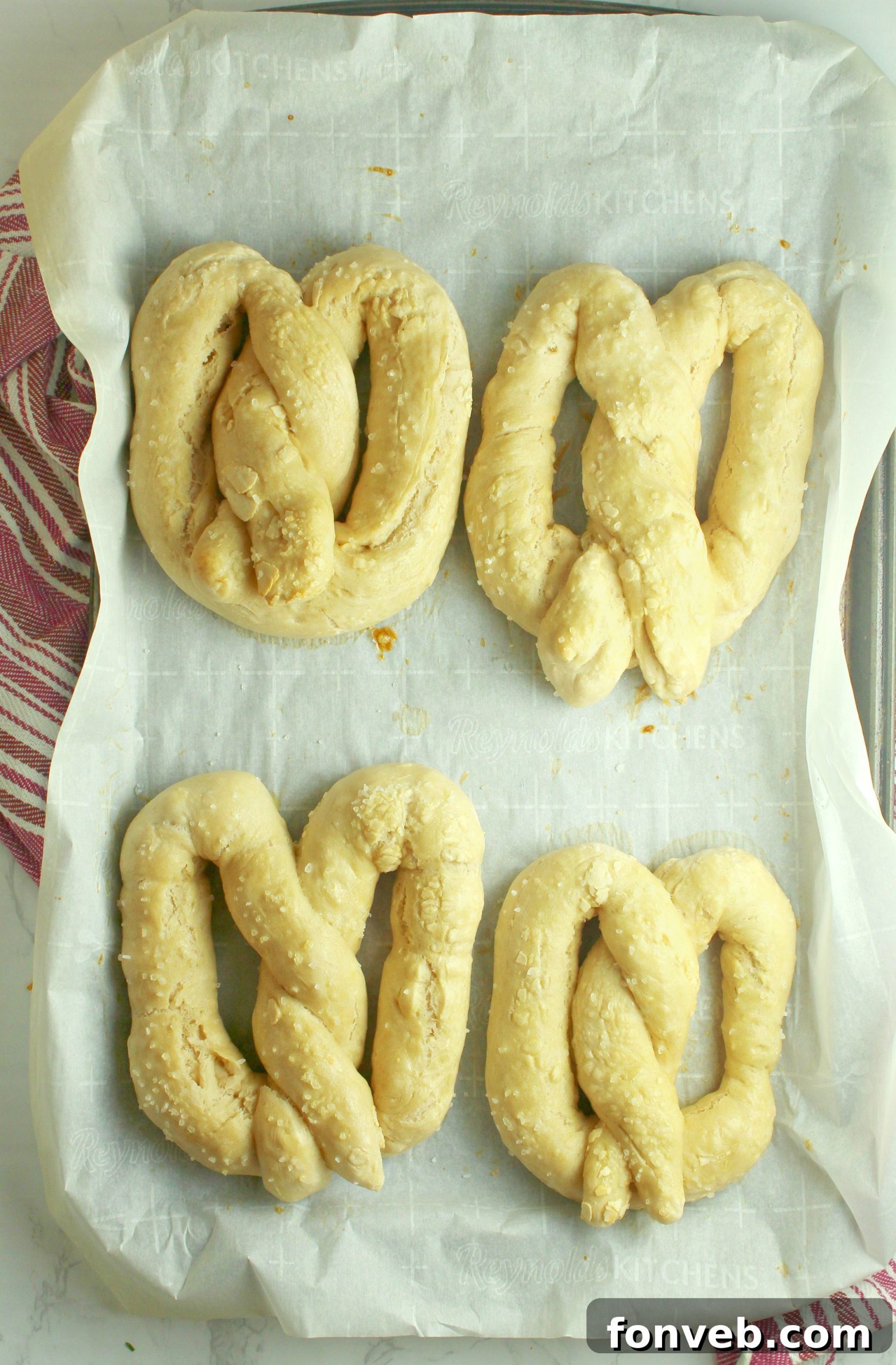 Warm Buttery Homemade Soft Pretzels 3 Close-up of a twisted raw pretzel dough on parchment paper