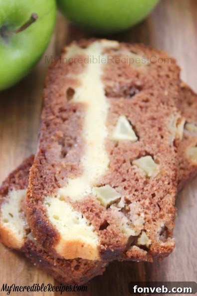 A slice of Cream Cheese Stuffed Apple Pie Bread on a plate, ready to be enjoyed