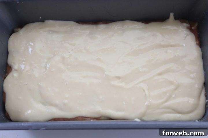 Loaf pan with layered batter, ready for the oven