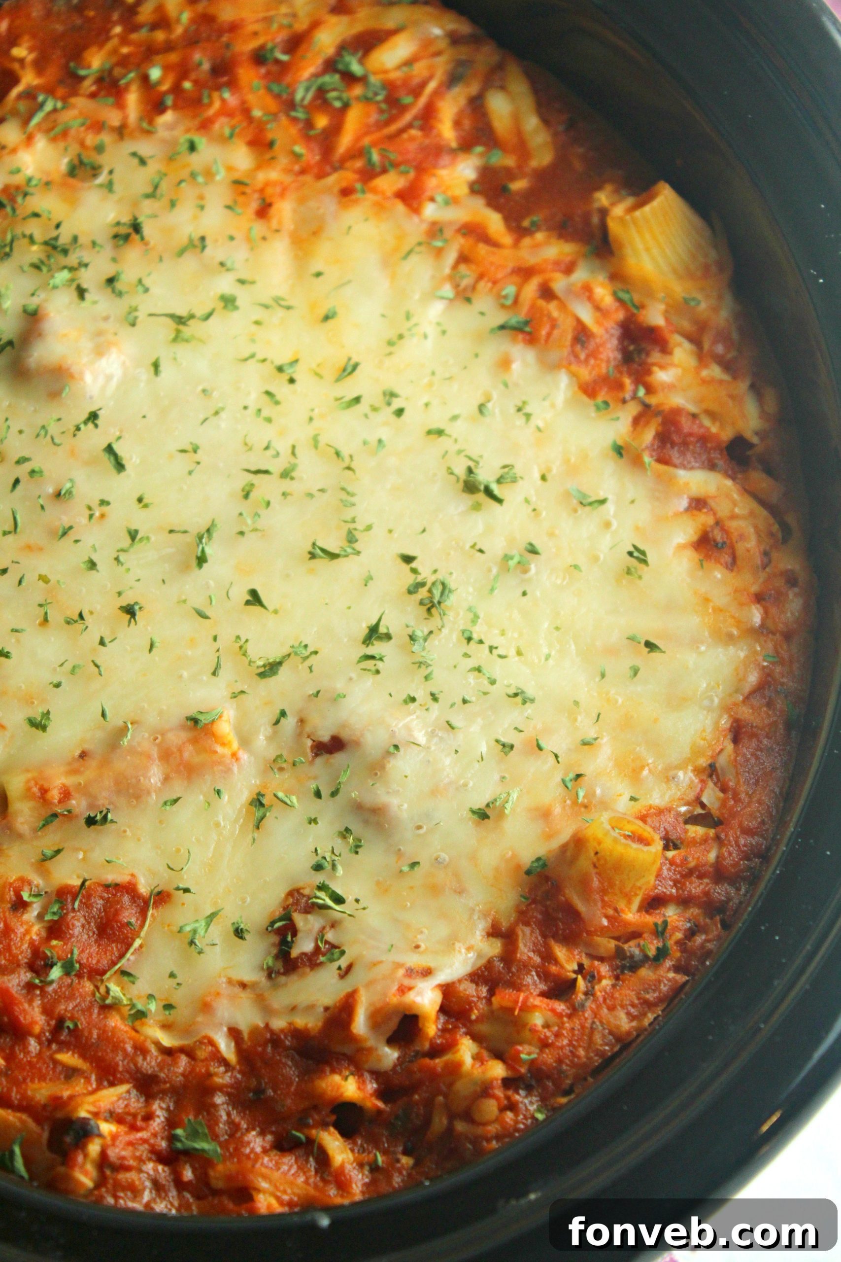Cooked slow cooker cheesy baked ziti ready to serve