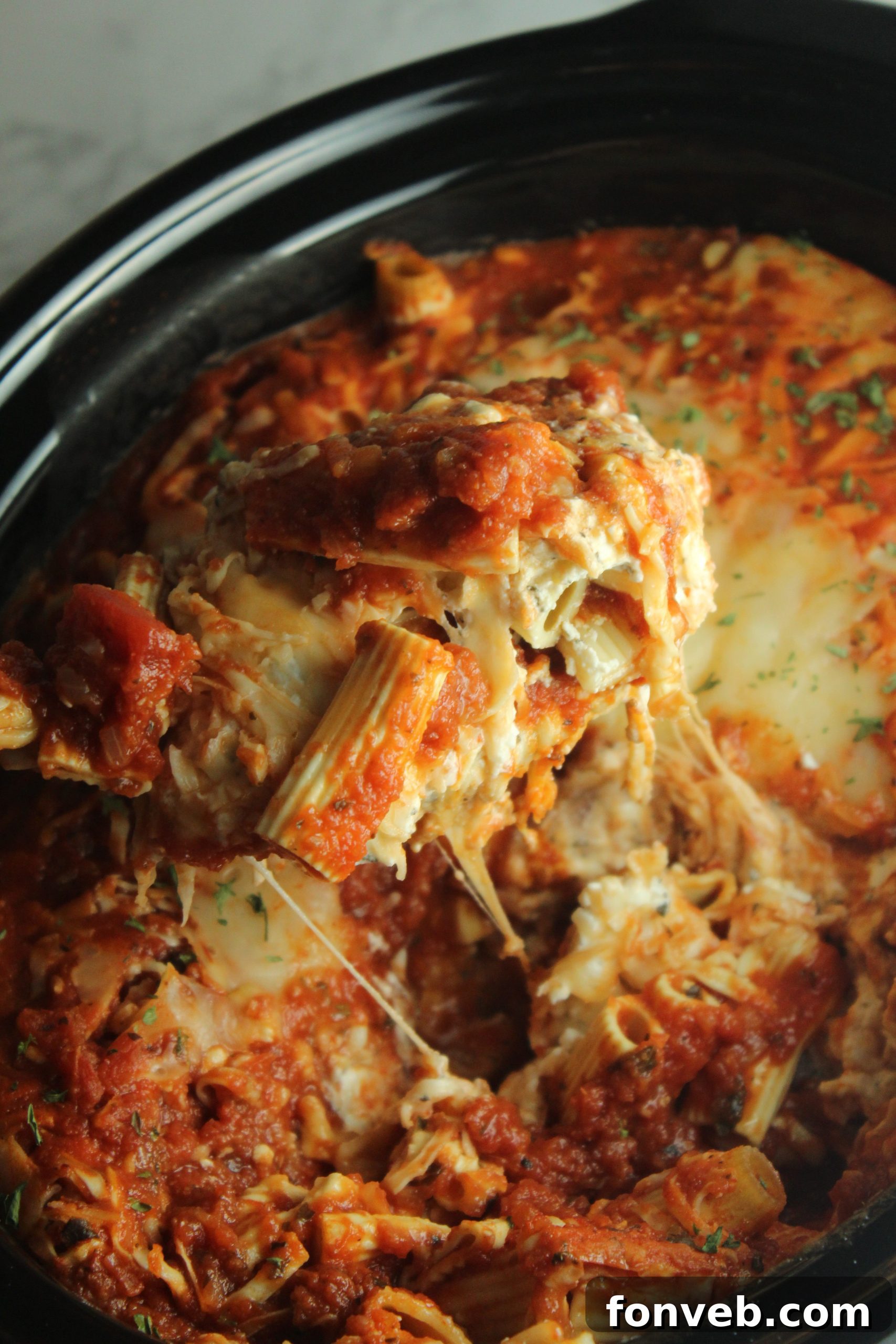 Individual portion of slow cooker cheesy baked ziti