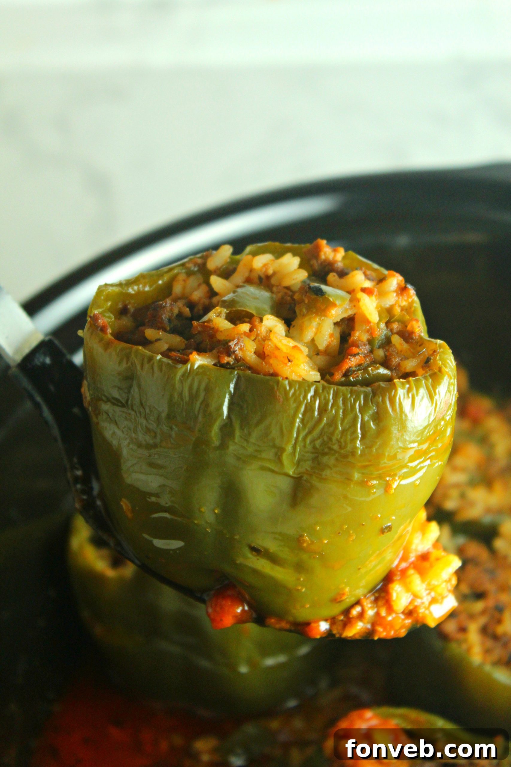 Another appealing view of Slow Cooker Stuffed Peppers, showing multiple peppers arranged in a slow cooker, ready to be served.