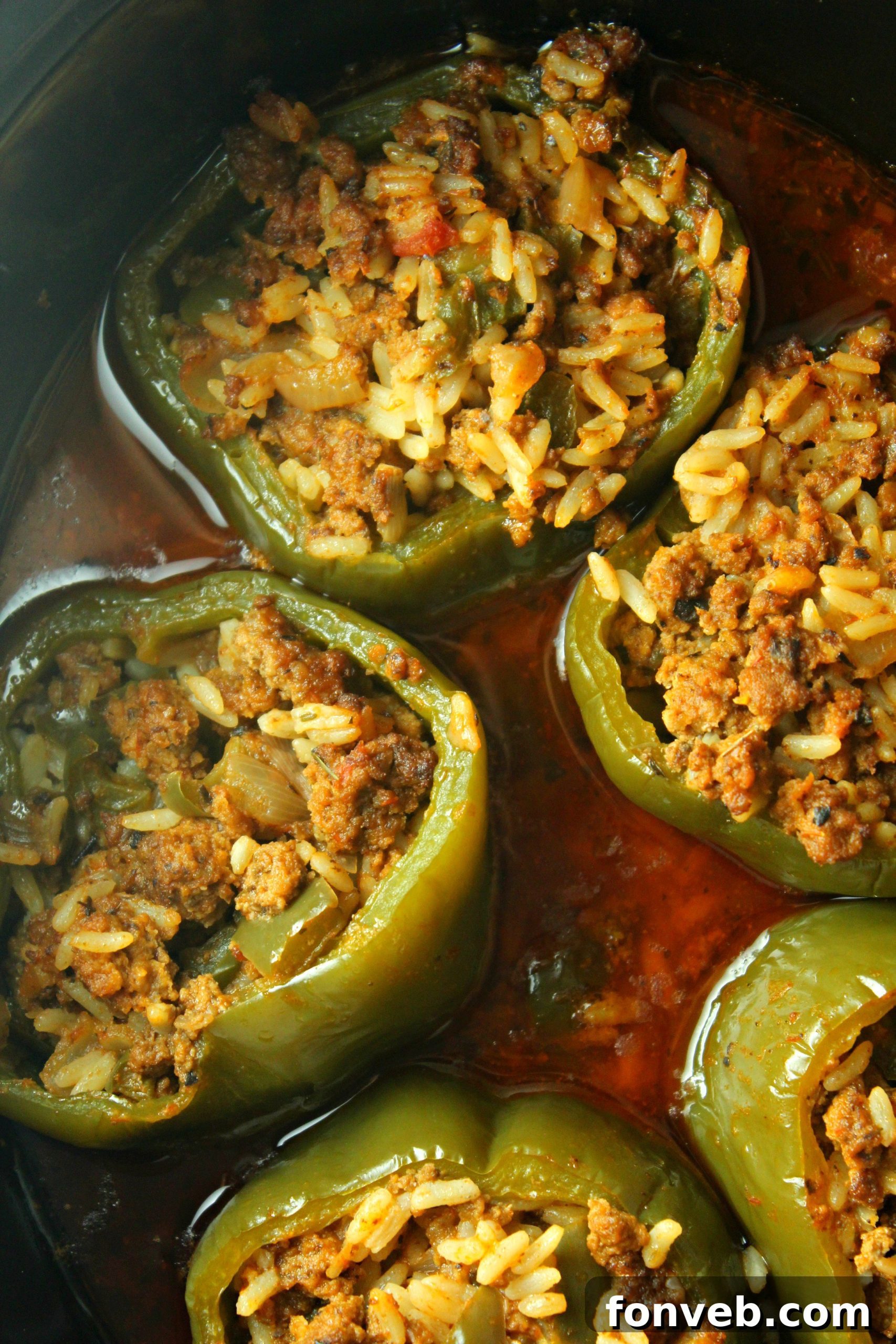 A freshly cooked Slow Cooker Stuffed Pepper being scooped out of the slow cooker with a serving spoon.