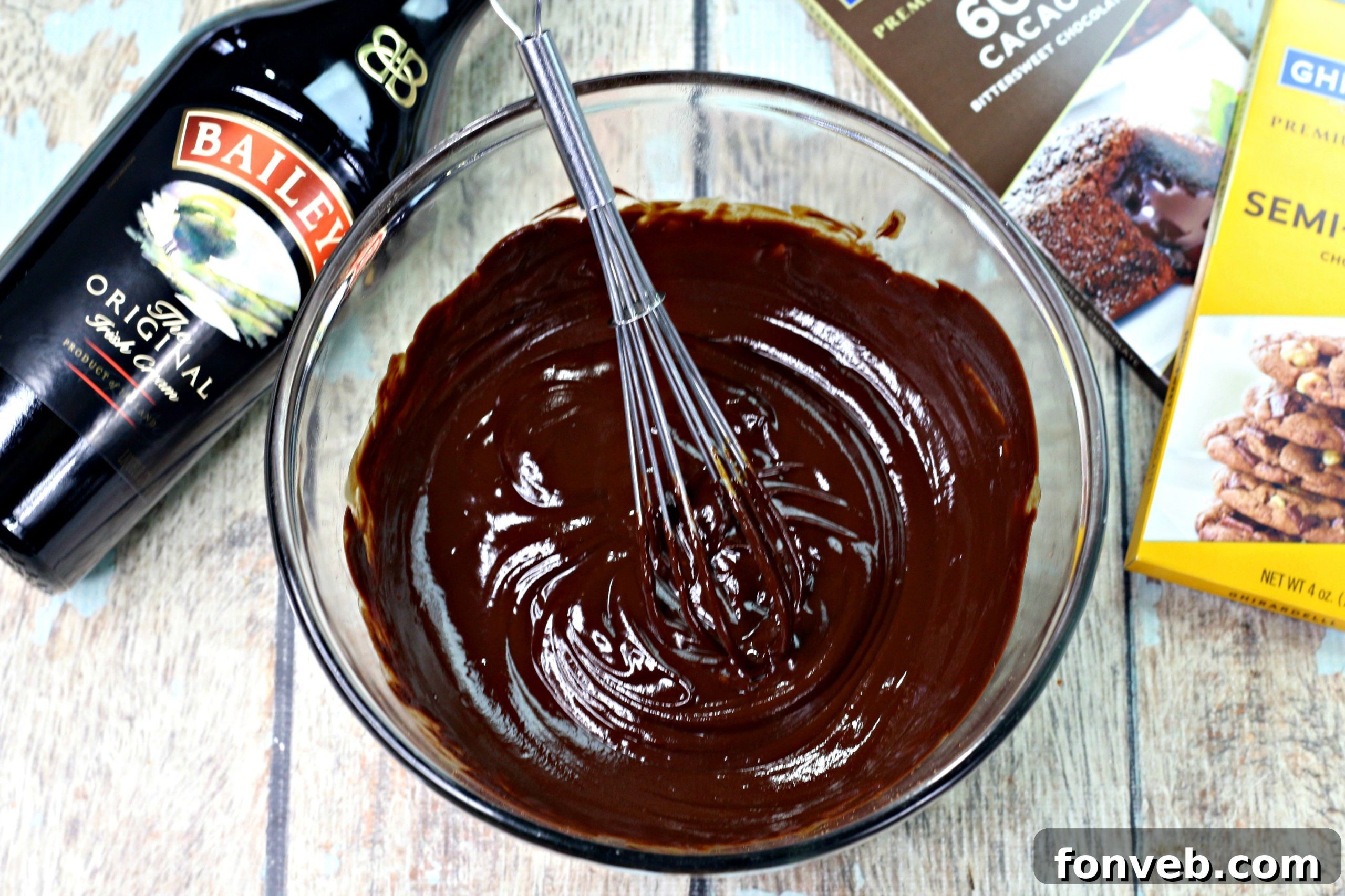 Essential ingredients for the truffles laid out, featuring premium chocolate bars and a bottle of Bailey's Irish Cream.