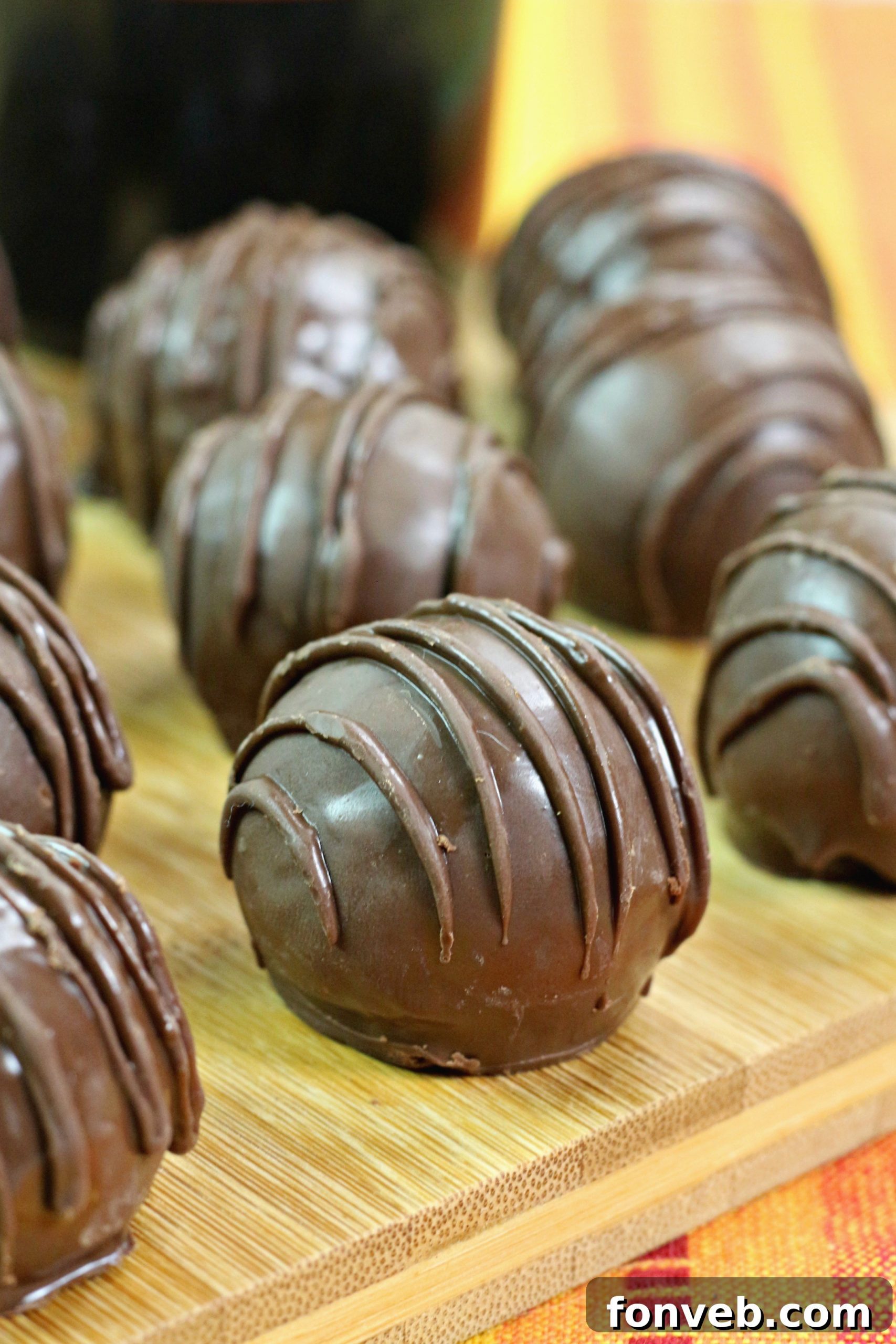 A close-up view of the smooth, dark chocolate coating on a finished Bailey's Irish Cream truffle, demonstrating its quality.