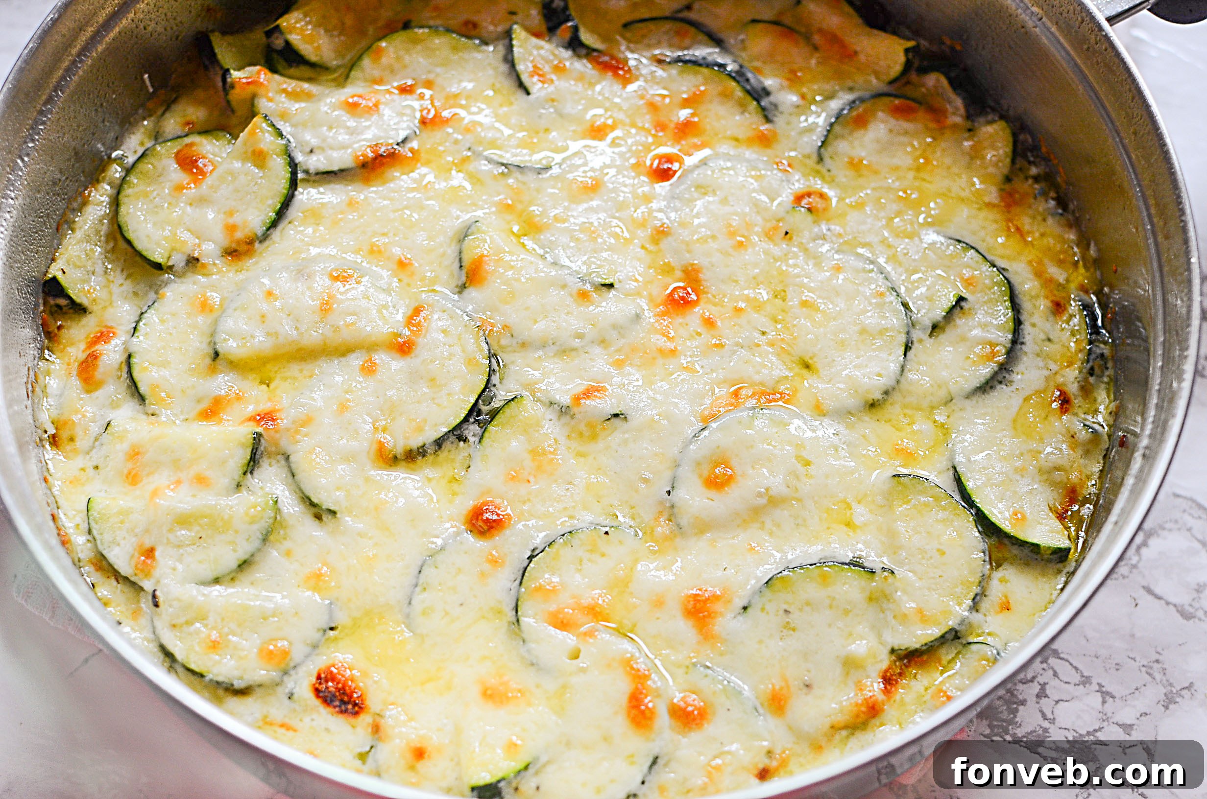 A delicious serving of Cheesy Zucchini Gratin, golden brown and bubbling, ready to eat
