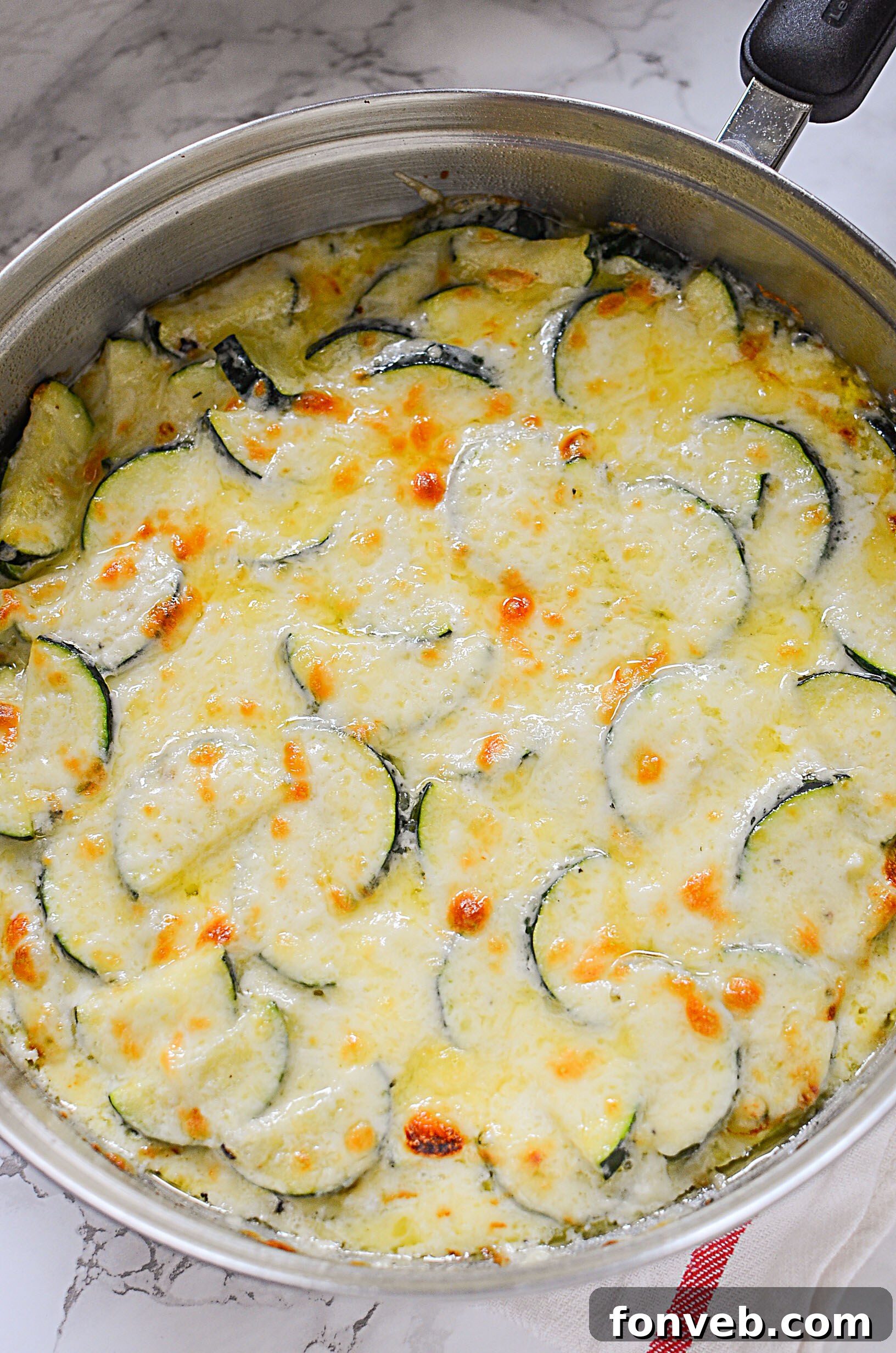 Close-up of golden-brown Cheesy Zucchini Gratin, steaming and inviting, fresh out of the oven