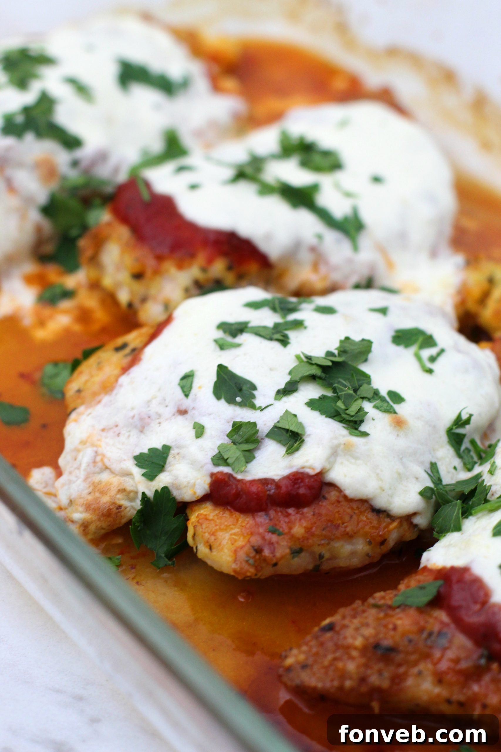 Keto Chicken Parmesan on a plate, garnished with fresh basil.