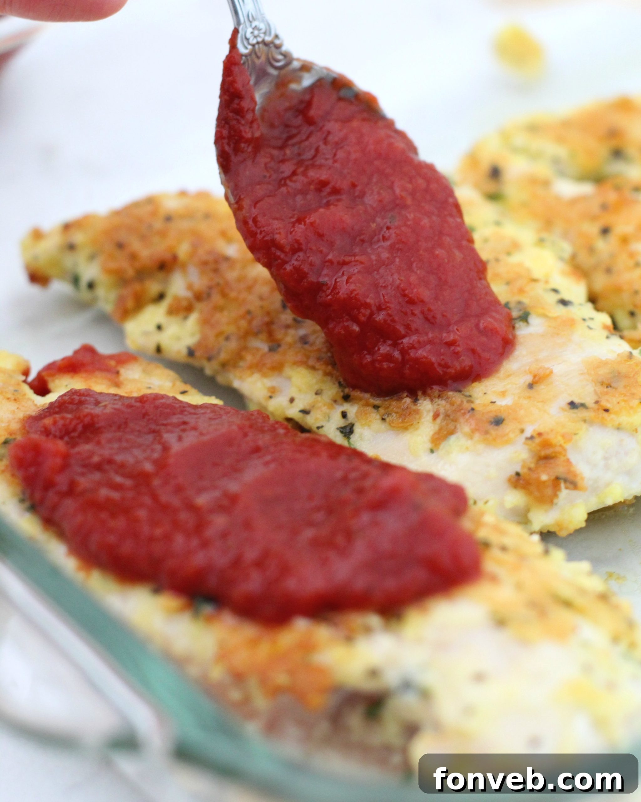 Close-up of golden-brown Keto Chicken Parmesan with melted cheese.