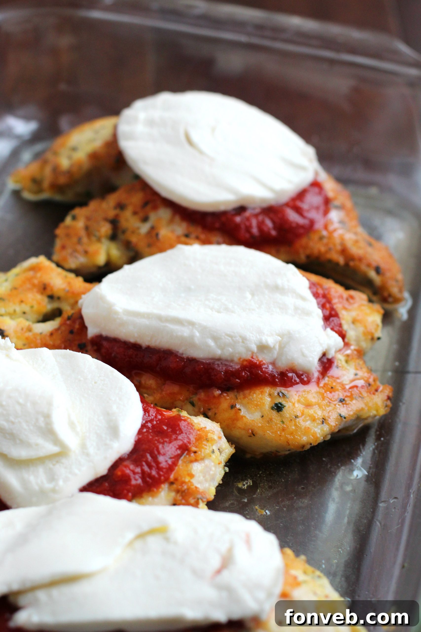 Ingredients for Keto Chicken Parmesan laid out on a table.