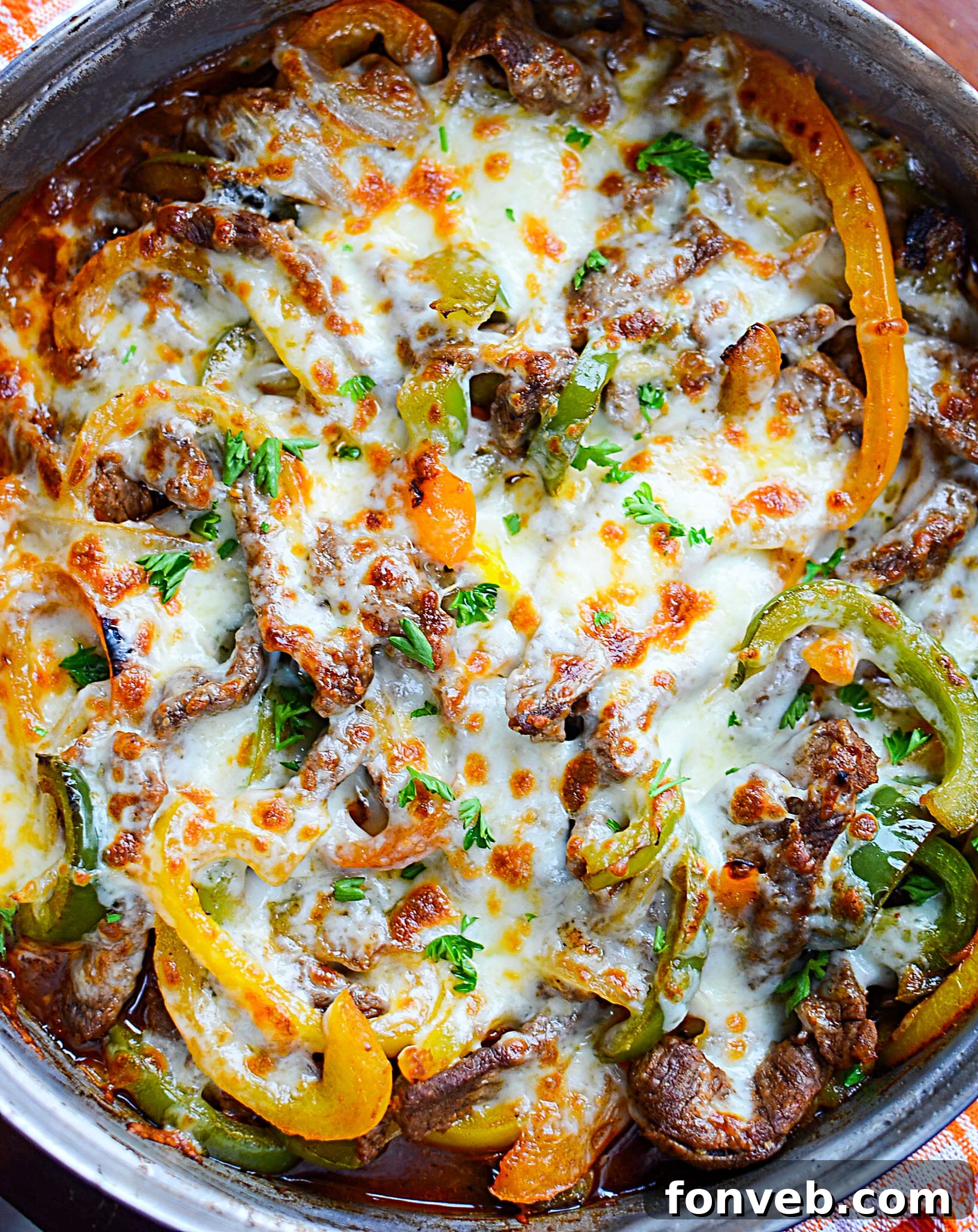 A close-up shot of a vibrant Low Carb Philly Cheesesteak Skillet, showcasing thinly sliced steak, colorful bell peppers, and melted cheese, ready to be served.