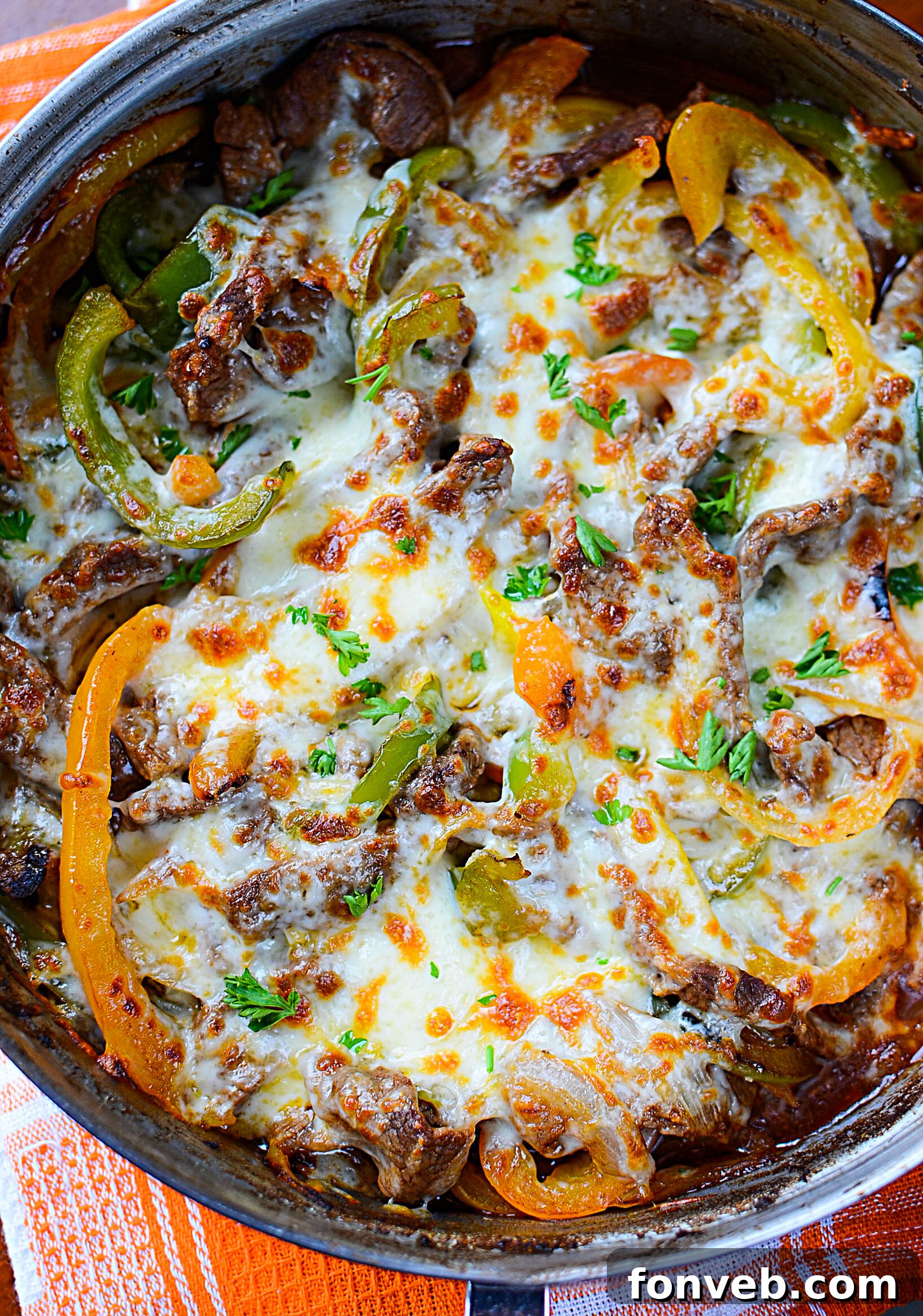 Close-up of the Low Carb Philly Cheesesteak Skillet, showing the melted cheese bubbling over the steak and vegetables.