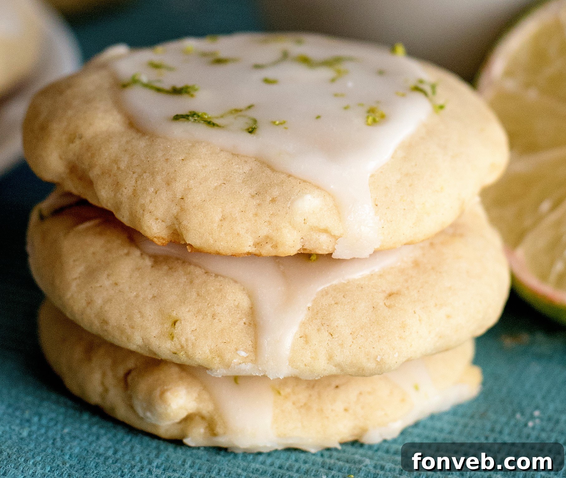 Plate of freshly baked Key Lime Pie Cookies with a vibrant green lime slice