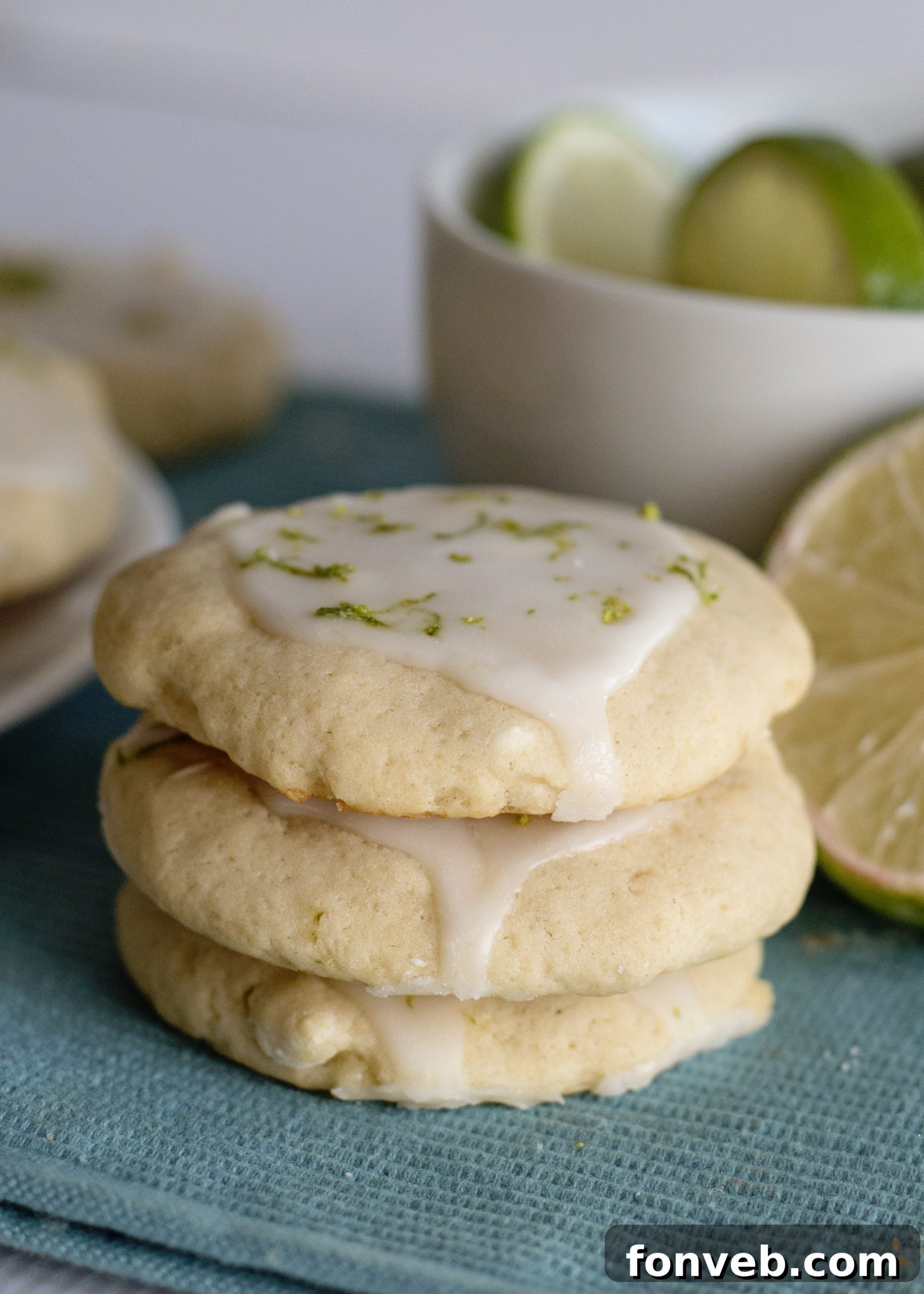 A hand pressing down on a lime on a countertop, demonstrating the juice extraction tip