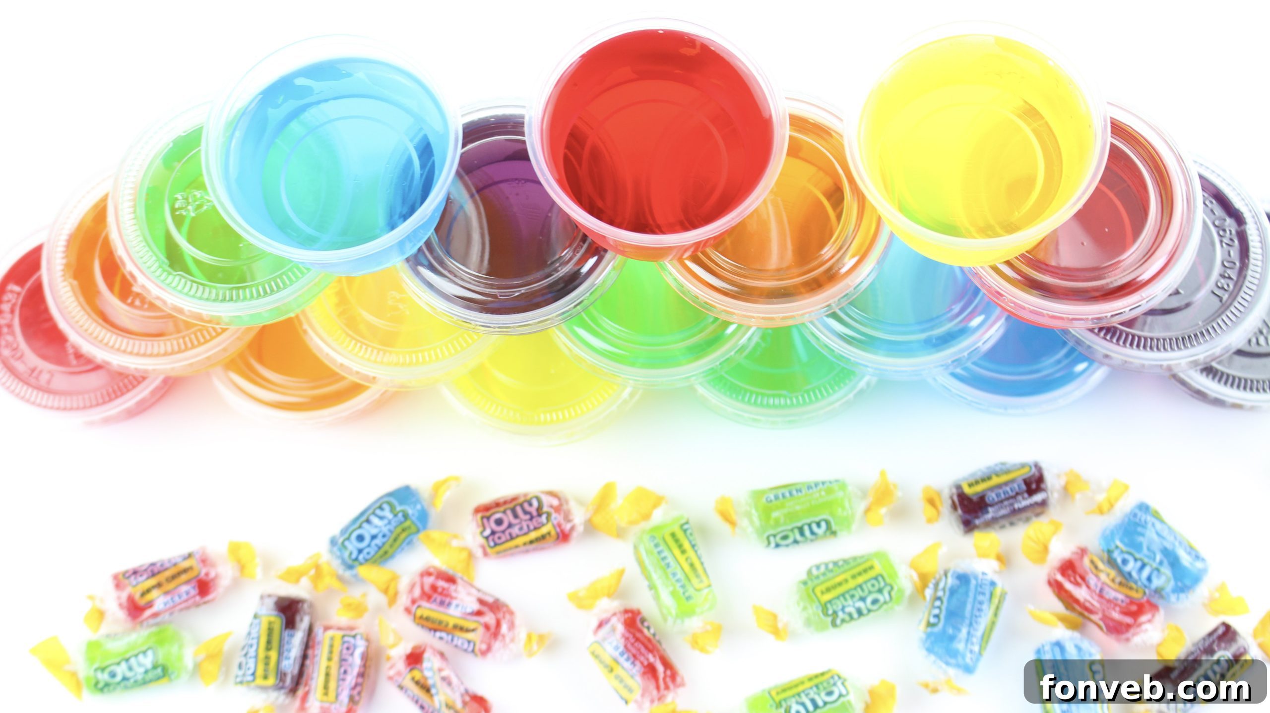 Two hands holding up a green and a red Jolly Rancher Jello Shot in clear plastic cups, cheering.