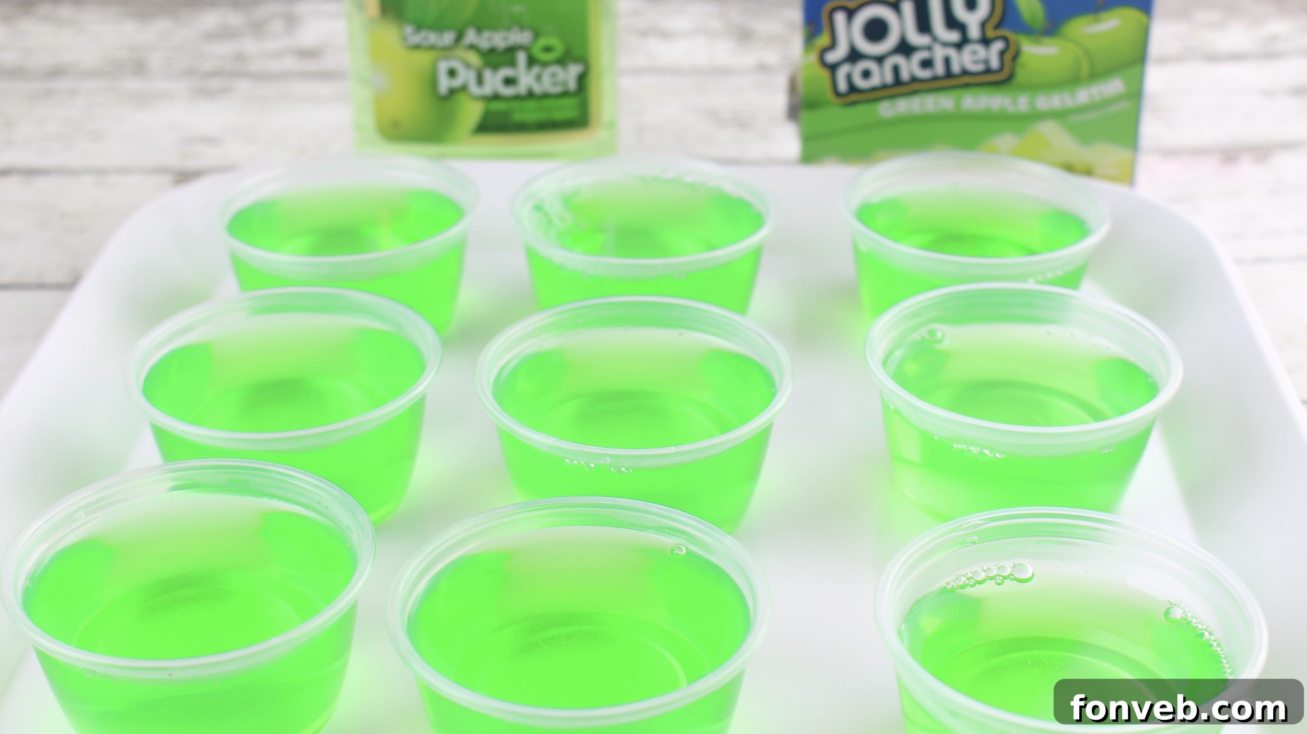 A close-up of a single purple Jolly Rancher Jello Shot in a plastic cup, perfectly set and ready to be enjoyed.