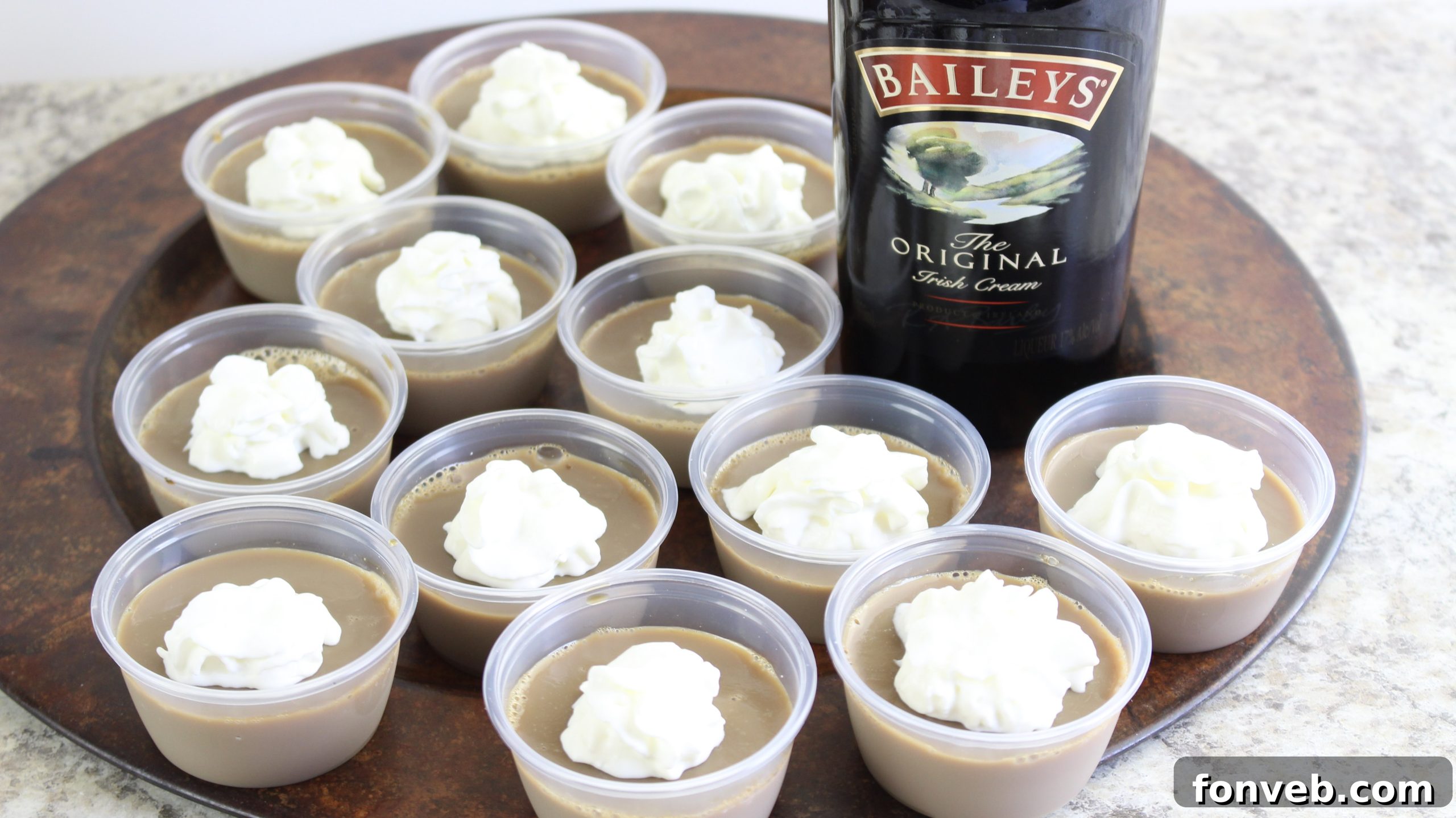 Close-up of Jello shots in clear cups with festive garnishes