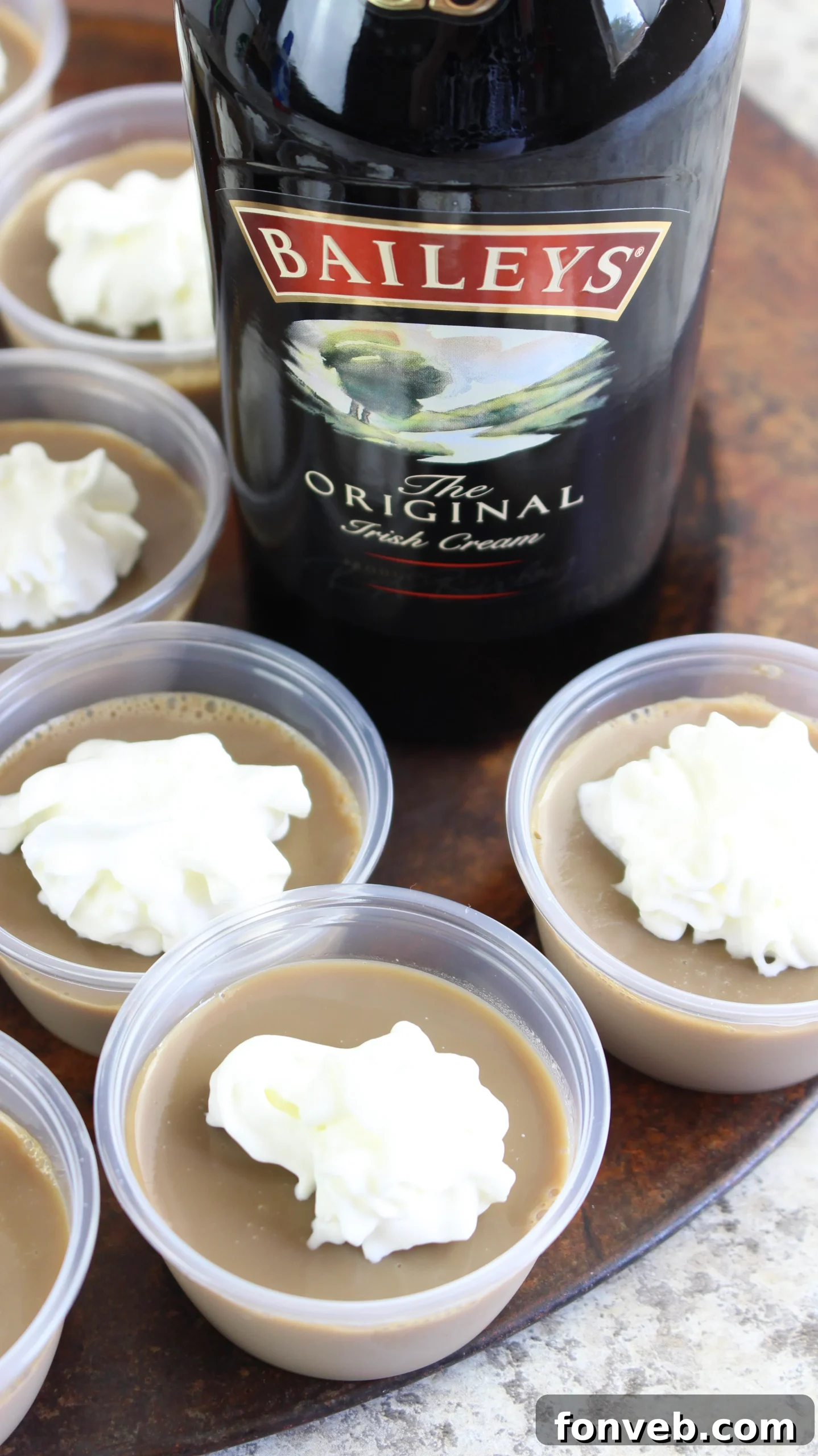 Baileys Irish Cream Jello Shots with a dollop of whipped cream on top, ready to serve