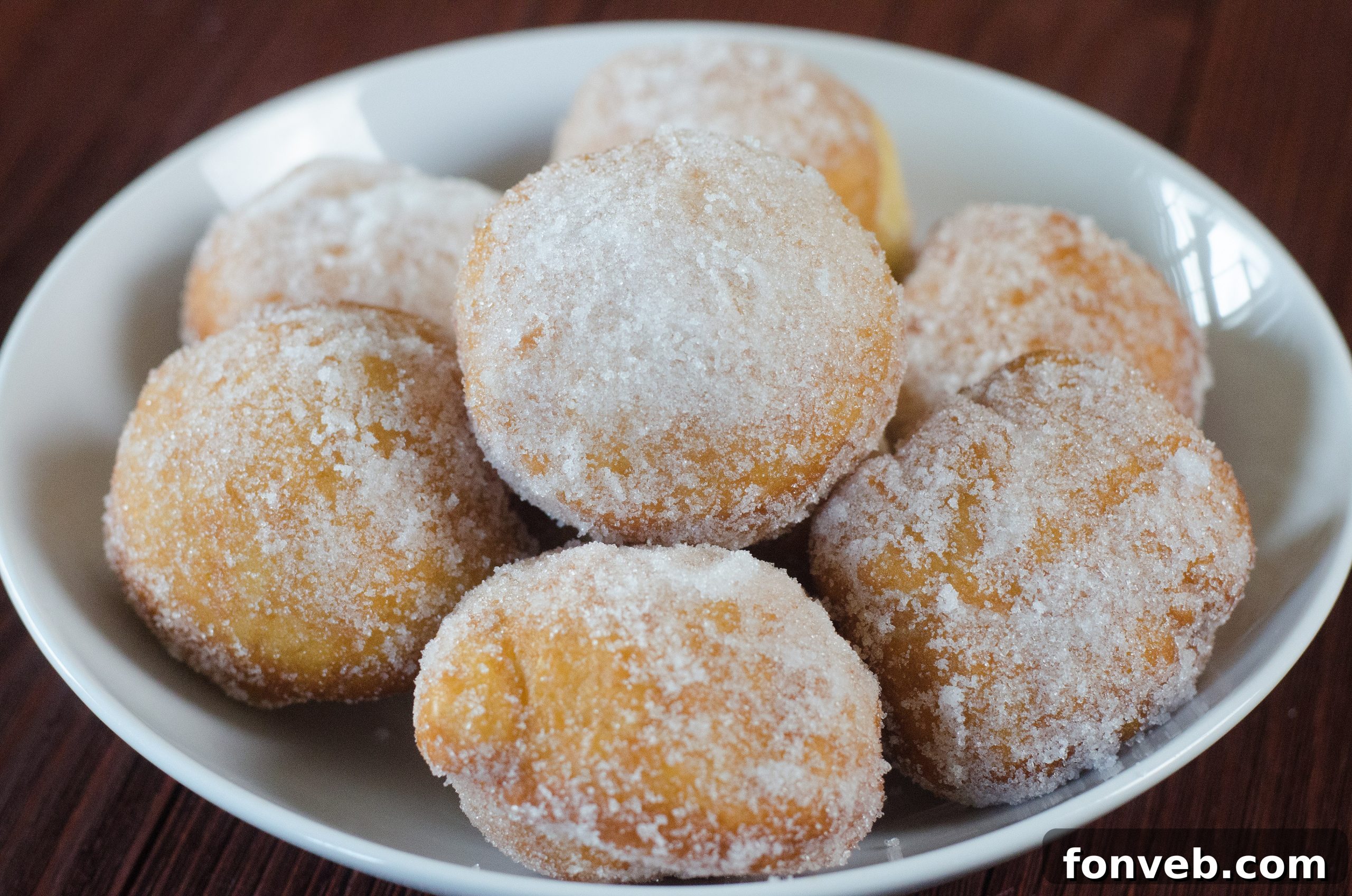 Chinese Fried Doughnuts 5 Closeup of a Chinese sugar donut with a bite taken, showing the soft interior.