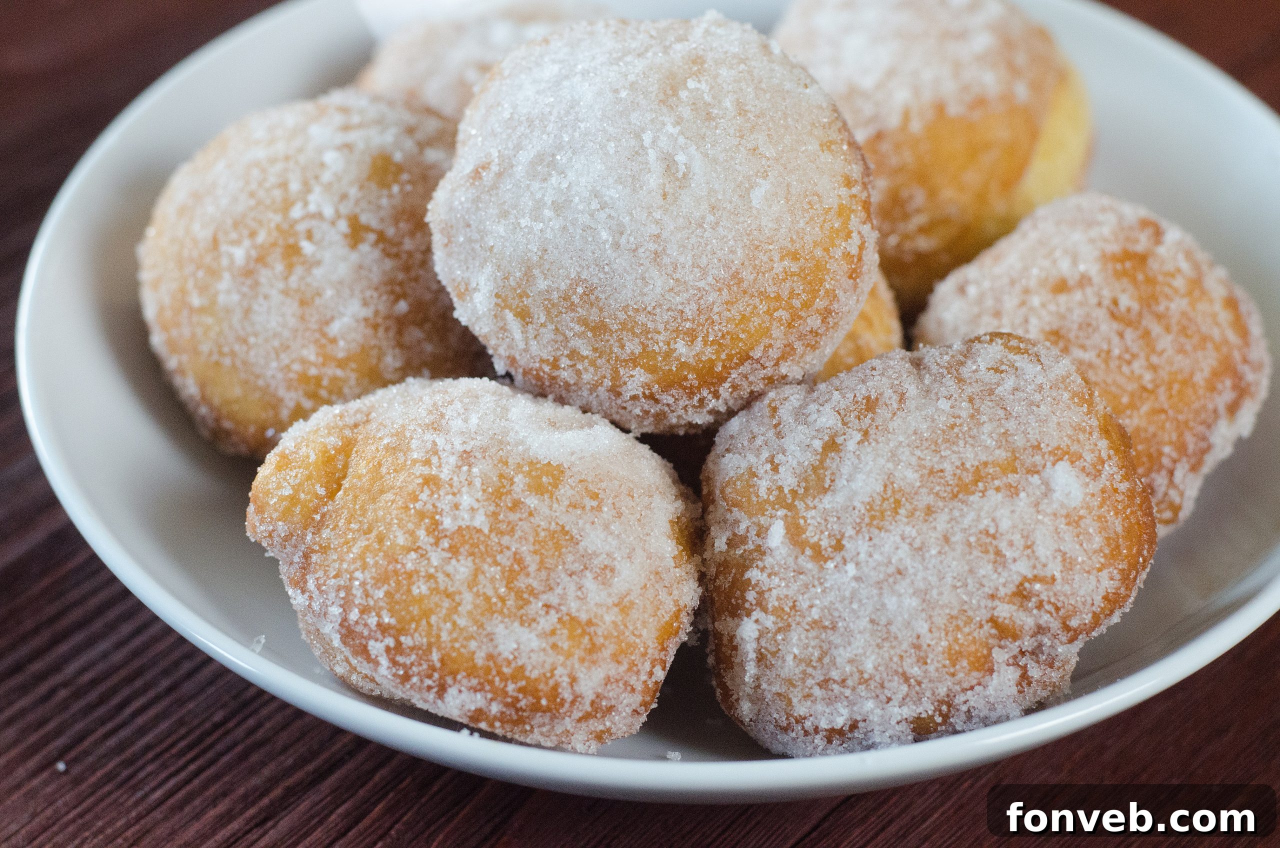 Chinese Fried Doughnuts 6 Overhead view of several Chinese sugar donuts arranged on a white plate.