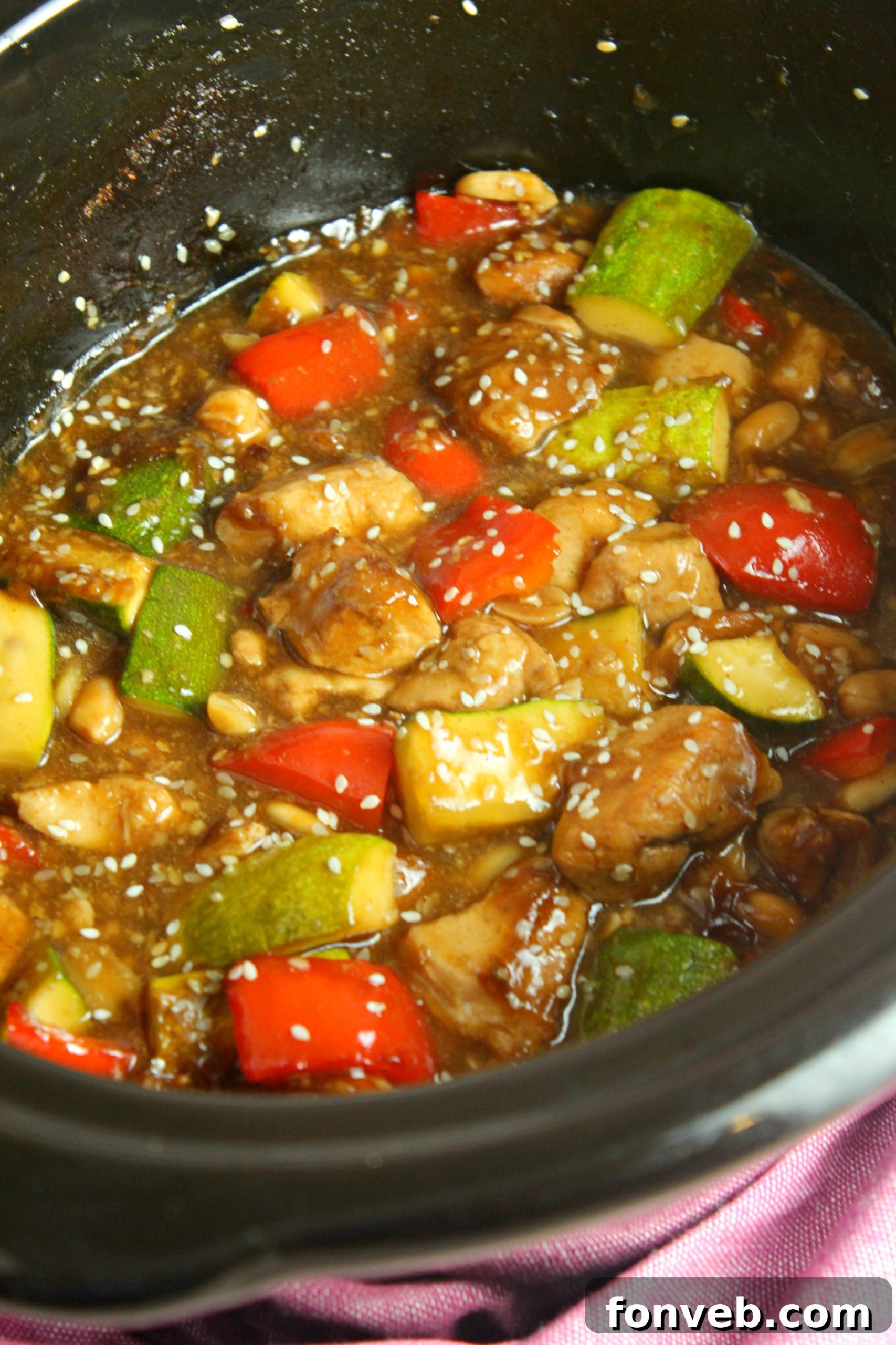 Close-up of the tender chicken texture and rich sauce of Slow Cooker Kung Pao Chicken.