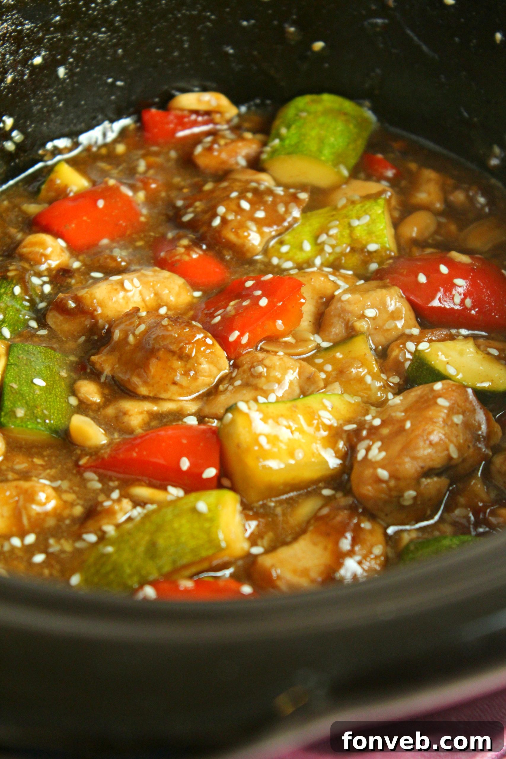 Slow Cooker Kung Pao Chicken simmering, showing the vibrant colors of the vegetables and sauce.