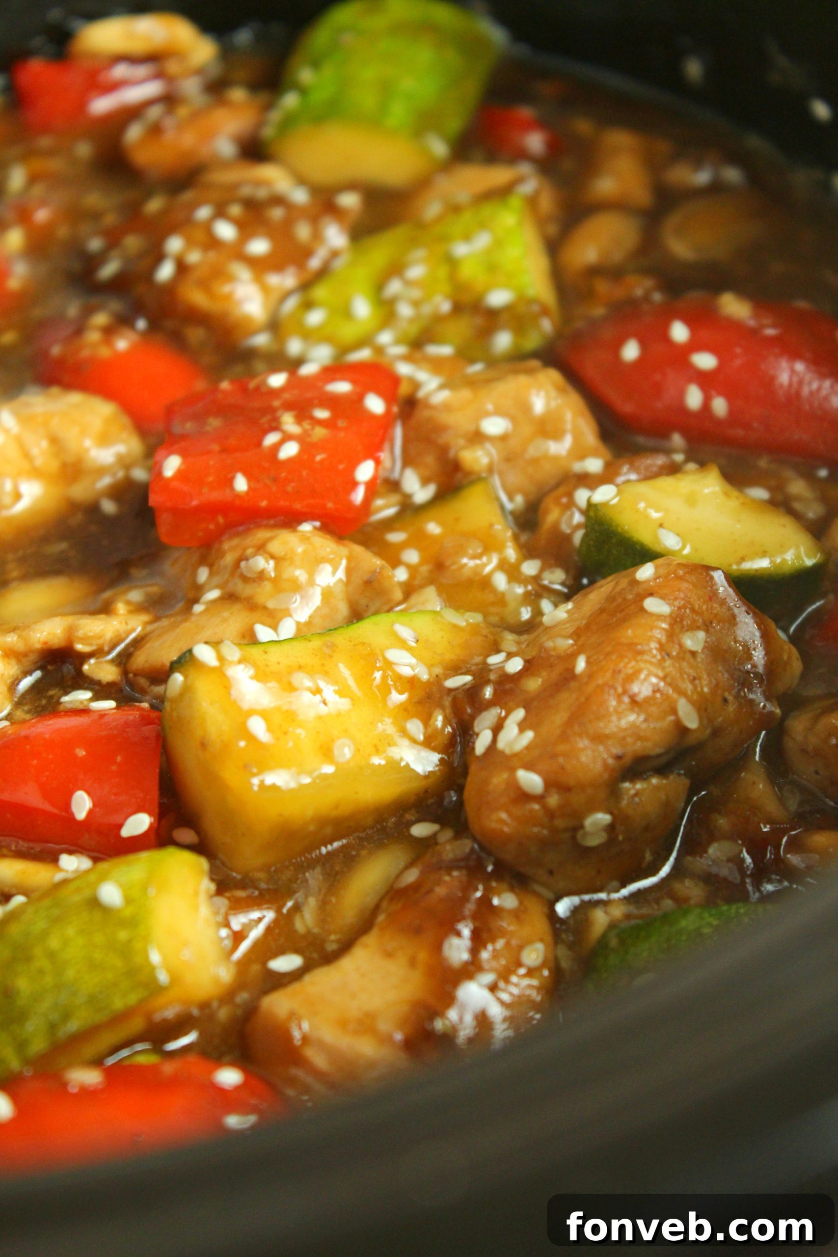 A bowl of Slow Cooker Kung Pao Chicken ready to be served, highlighting its rich texture and color.