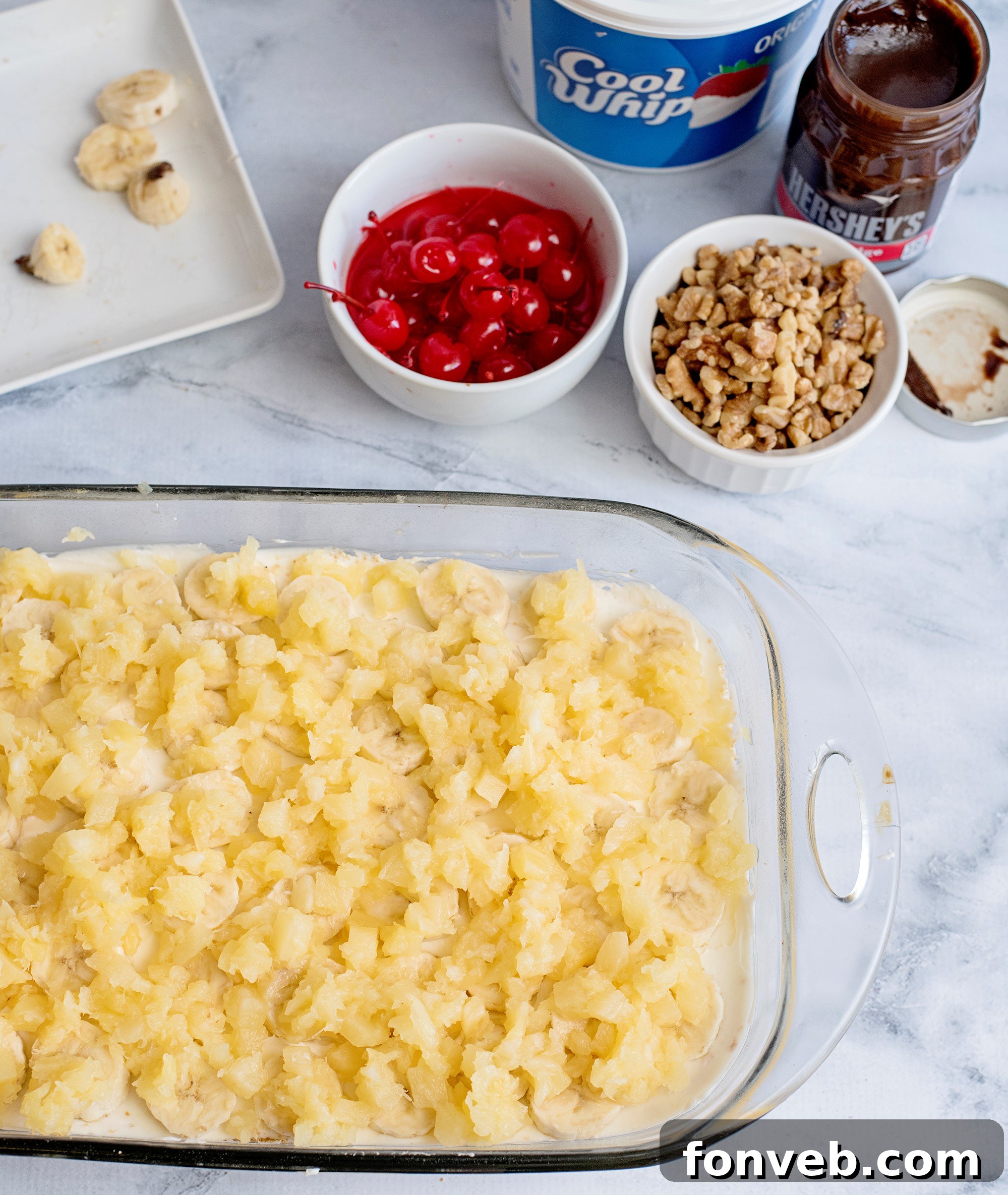 No Bake Banana Split Dream 5 A neatly sliced piece of No-Bake Banana Split Dessert, showcasing its perfect layers and inviting presentation on a plate.