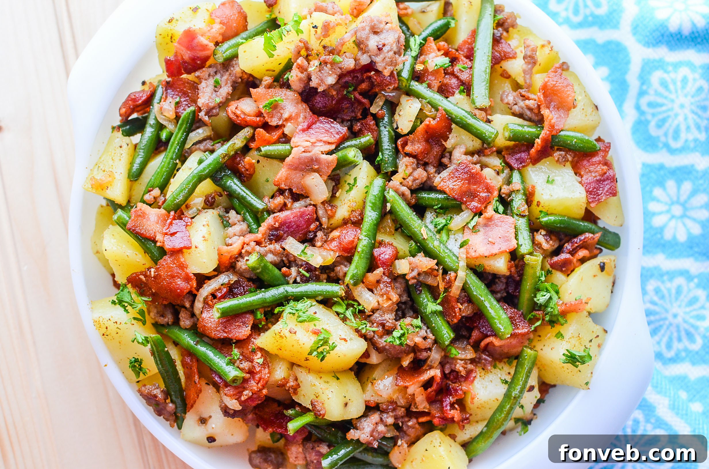 Final presentation of the Southern Sausage, Potatoes, and Green Beans in a bowl, garnished and ready.