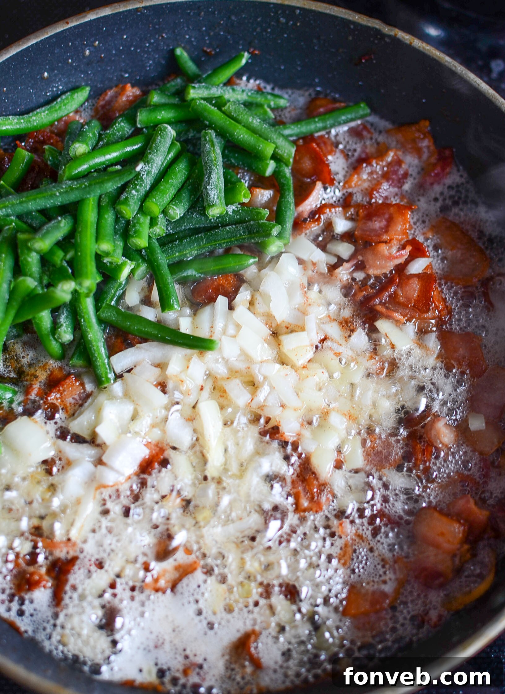 Close-up of cooked Southern Sausage, Potatoes, and Green Beans in a pan, showcasing the rich texture and ingredients.