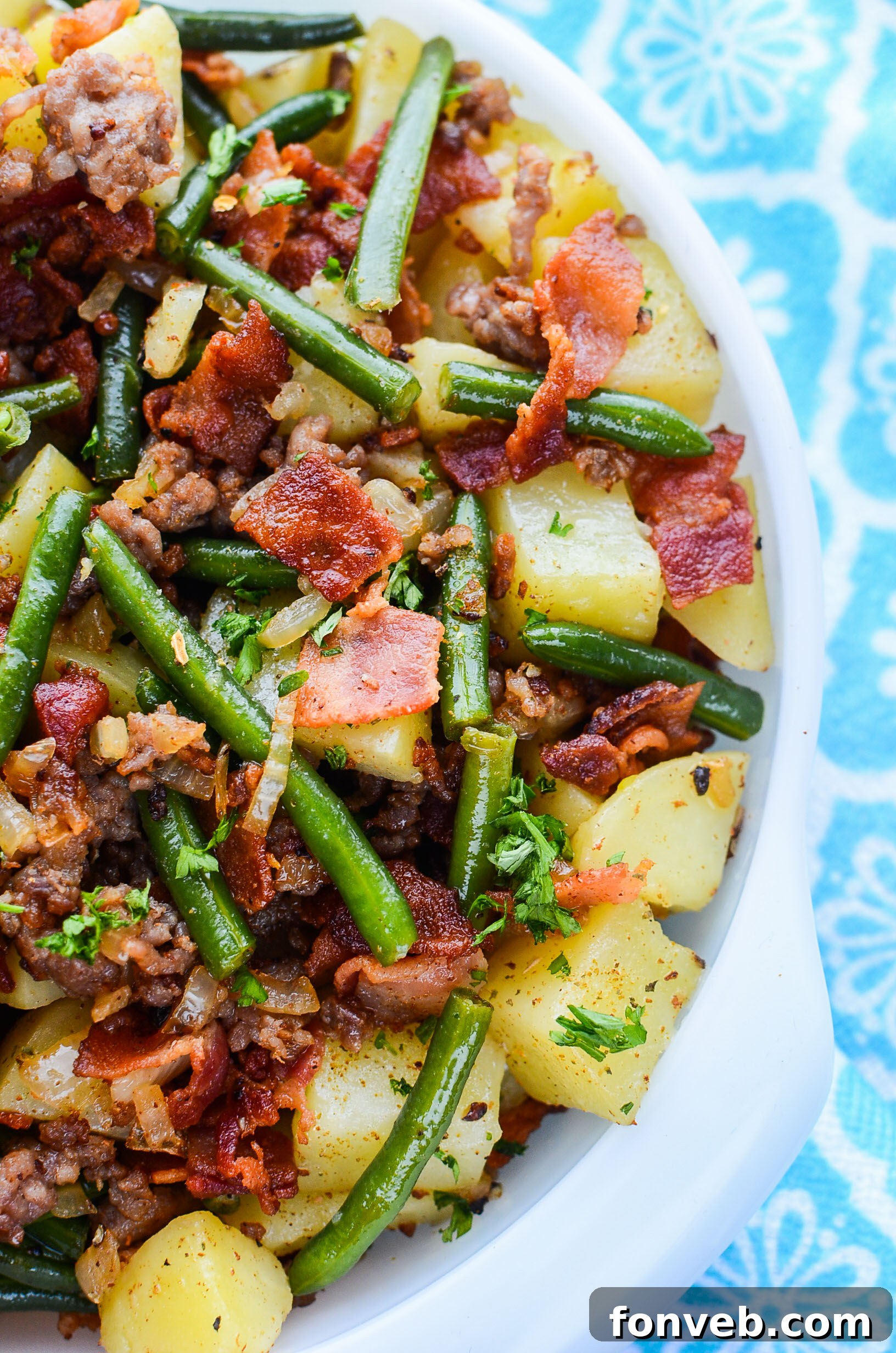 A full spread of the Southern Sausage, Potatoes, and Green Beans in a large pot on a stovetop, ready to be dished out.