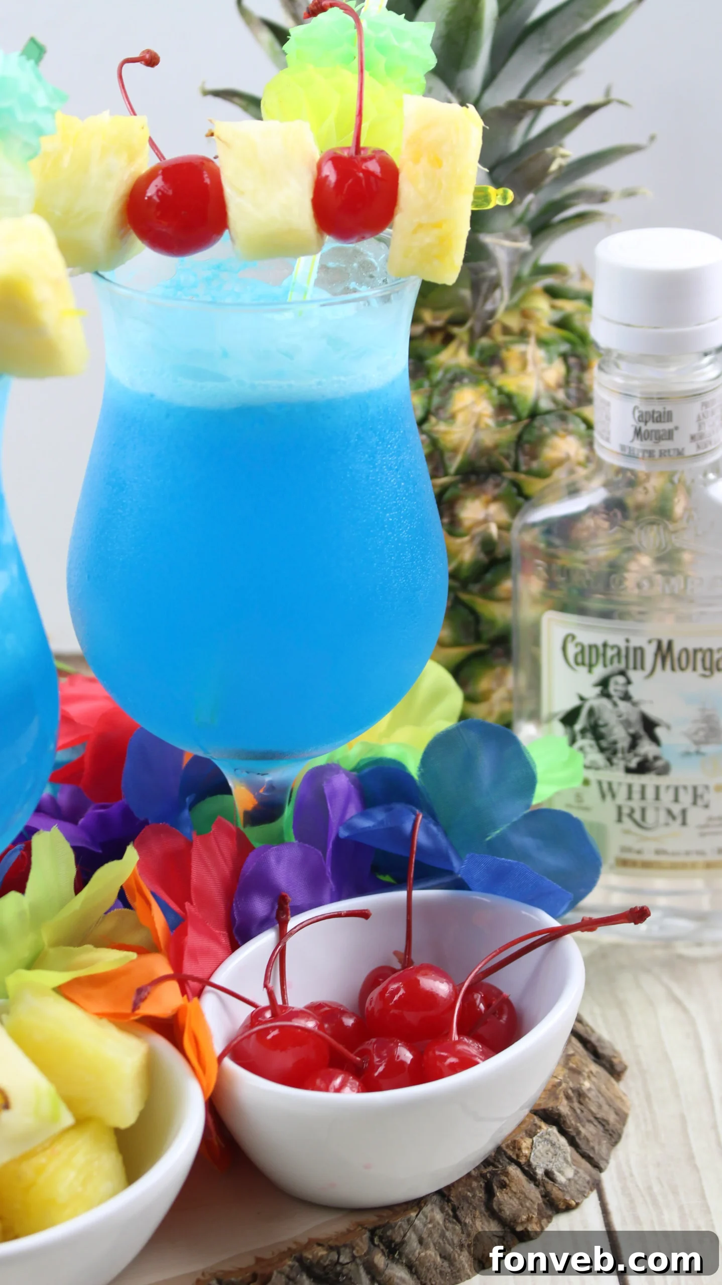 Blue Hawaiian Tropical Escape 5 Ingredients for a Blue Hawaiian cocktail, including pineapple juice, blue curacao, rum, and coconut cream.