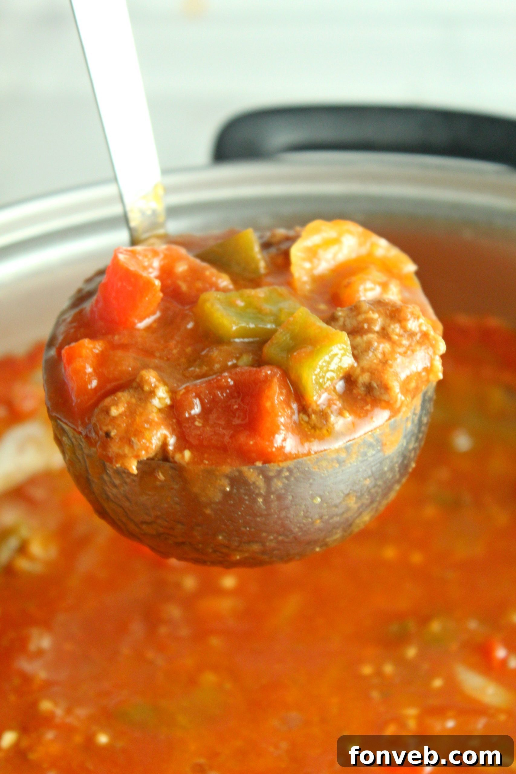 Rustic Stuffed Bell Pepper Soup 2 A vibrant bowl of hearty stuffed pepper soup, rich with ground beef, bell peppers, and a savory tomato broth, garnished with fresh herbs.