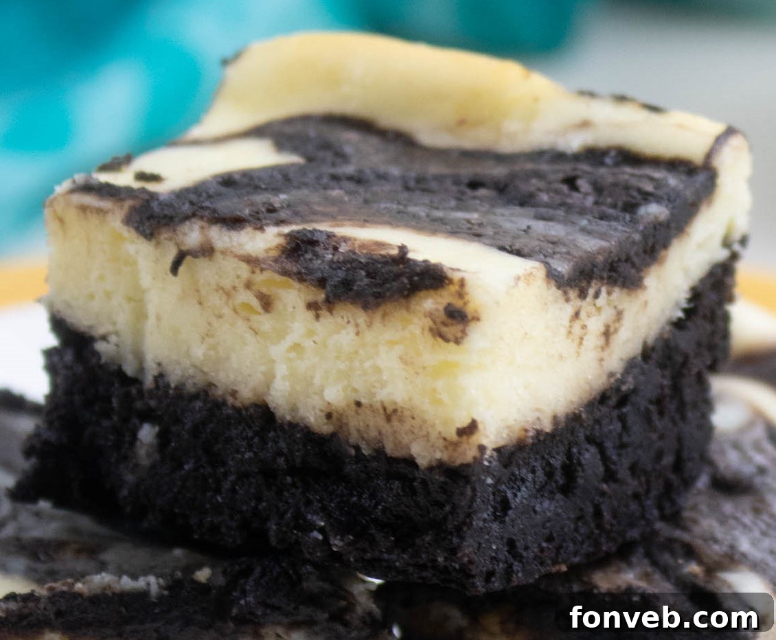Close-up of the textured top of a Cheesecake Swirl Brownie, showing the baked swirl.