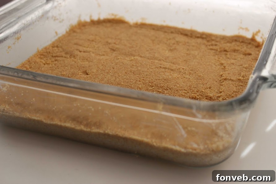 Golden brown graham cracker crust in a baking pan