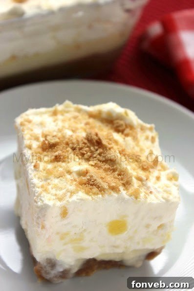 A large slice of pineapple lush dessert ready to be served