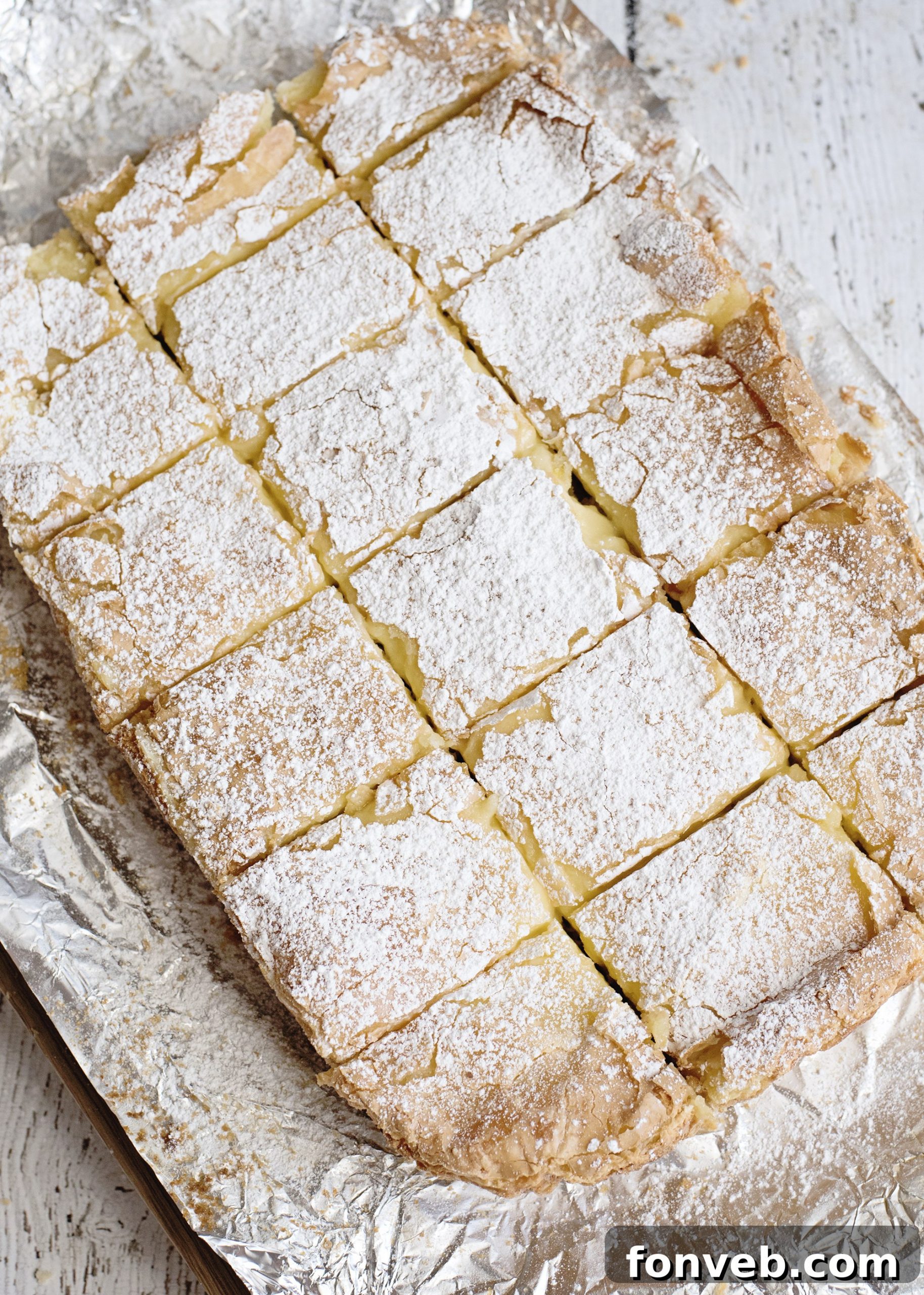 A perfectly portioned square of Ooey Gooey Butter Bar, showing the distinct crust and creamy topping.