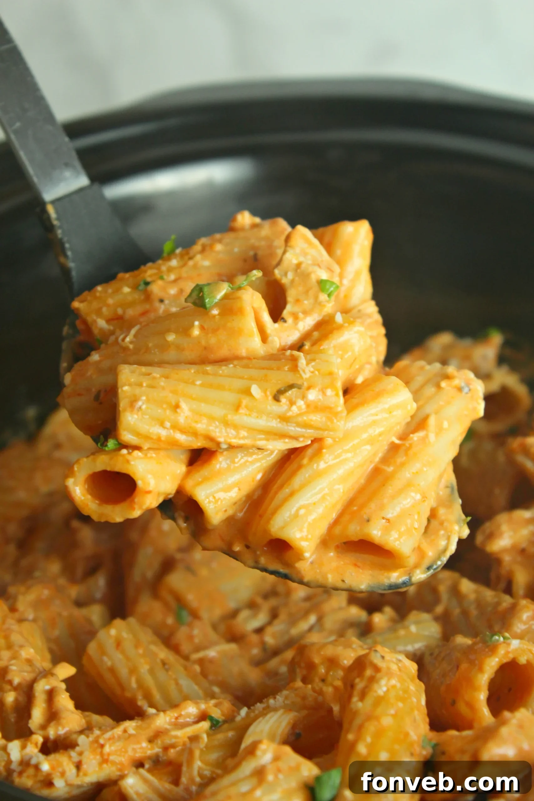 Velvety Slow Cooker Chicken Rigatoni 2 Delicious Slow Cooker Creamy Chicken Rigatoni served in a bowl, garnished with fresh parsley.