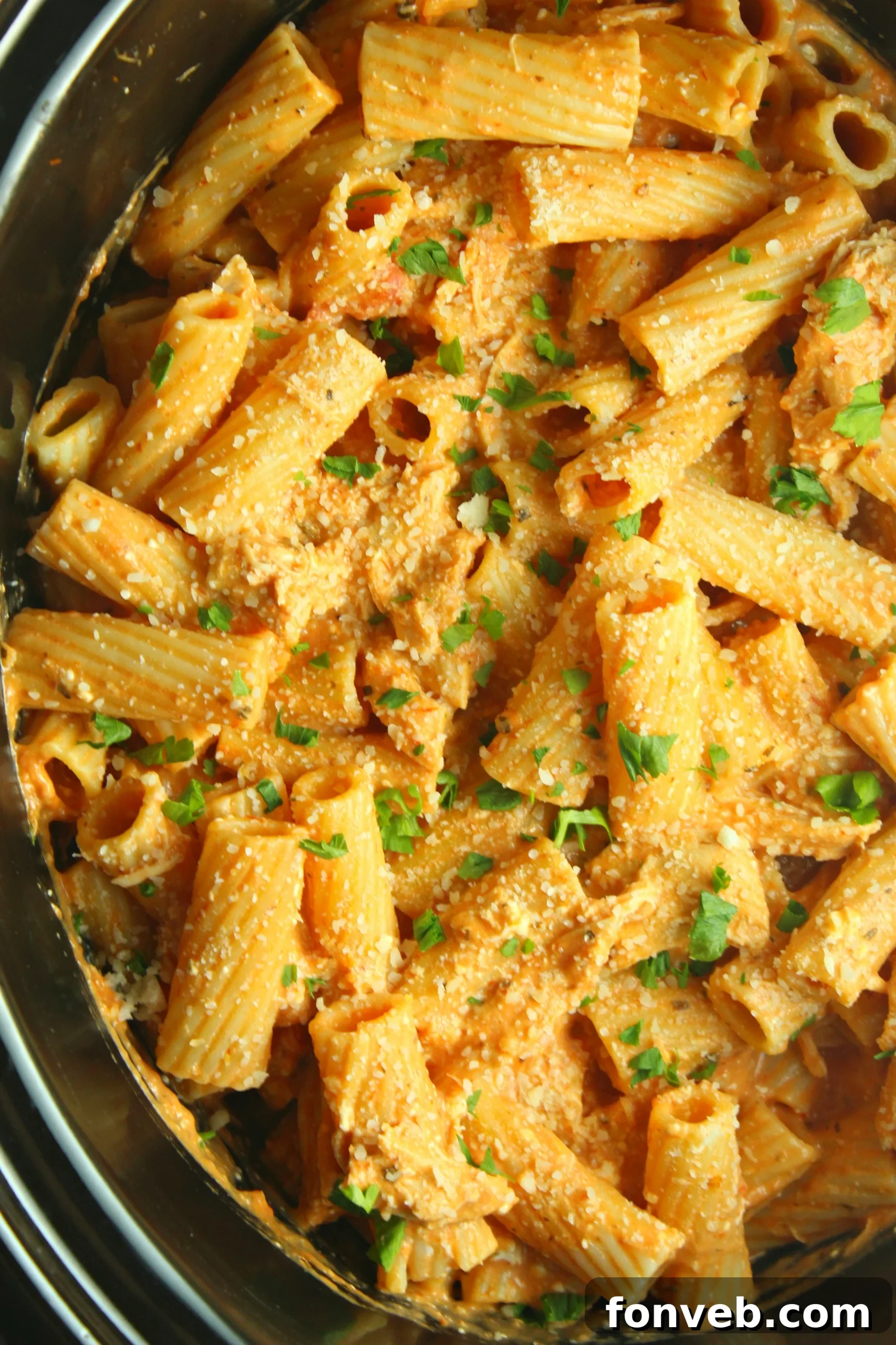 Velvety Slow Cooker Chicken Rigatoni 6 A serving of creamy chicken rigatoni in a white bowl, ready to be enjoyed.