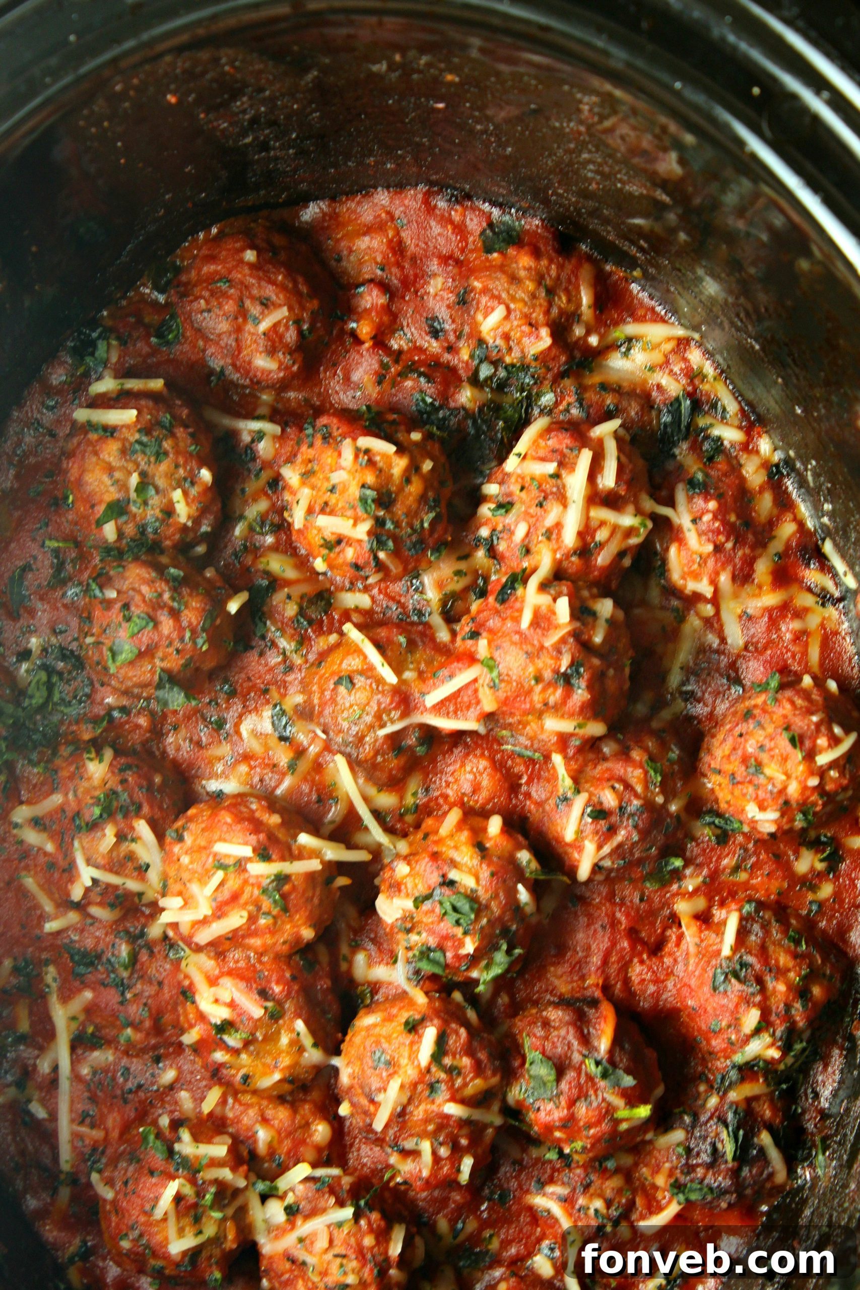 Close up of slow cooker meatballs in red sauce