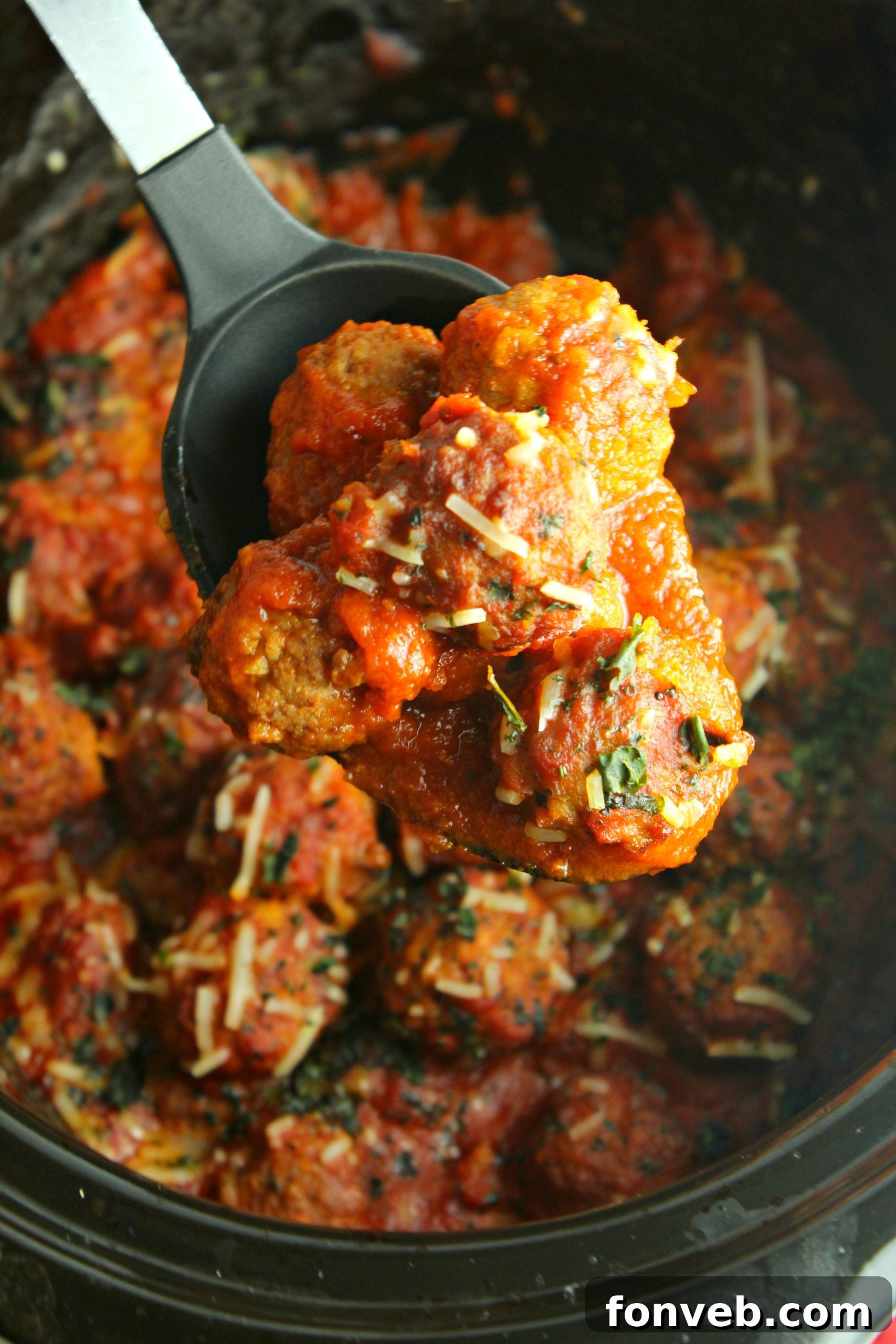 Slow cooker meatballs and sauce served over pasta