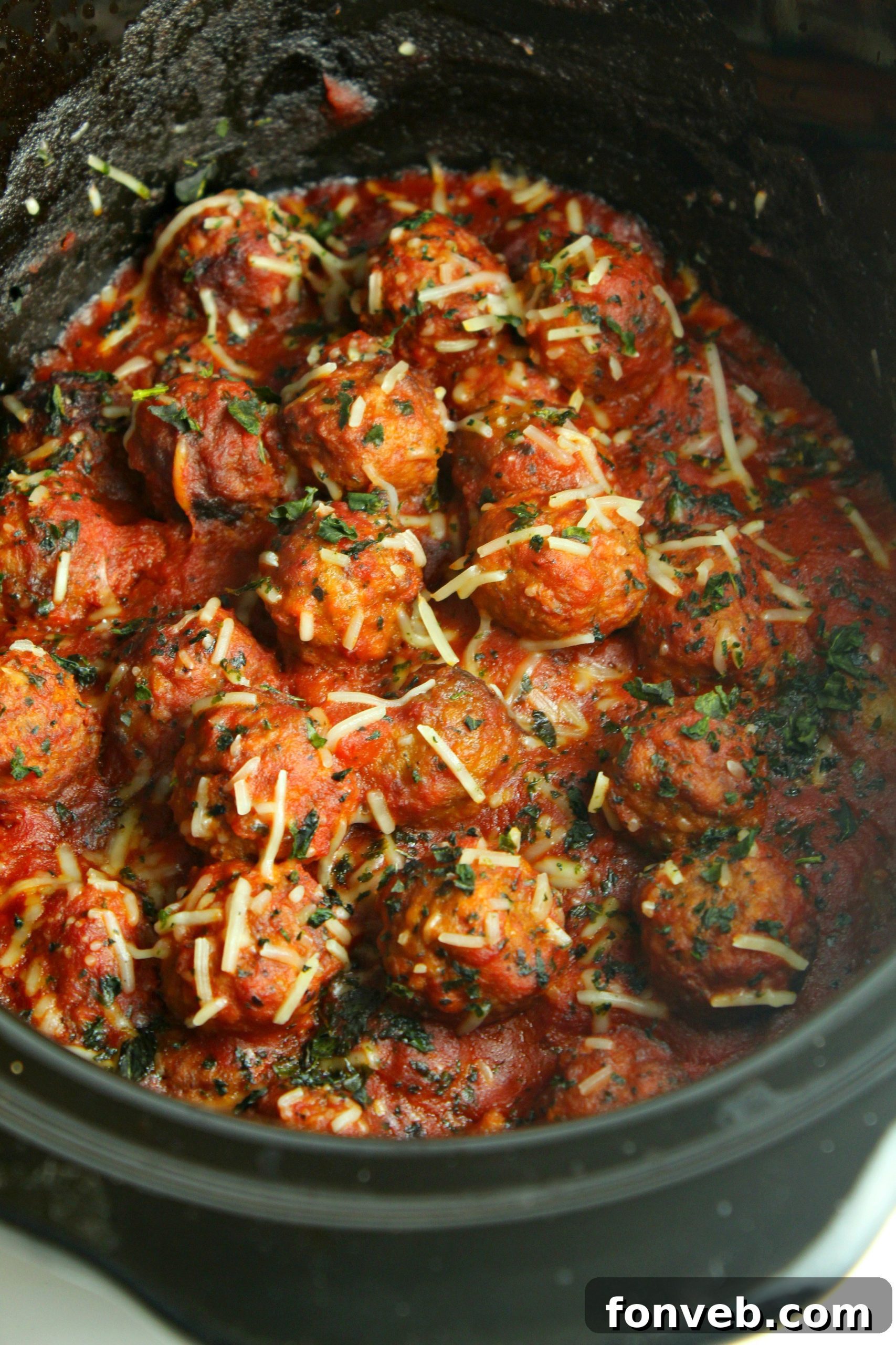 Slow cooker meatballs and sauce with fresh basil