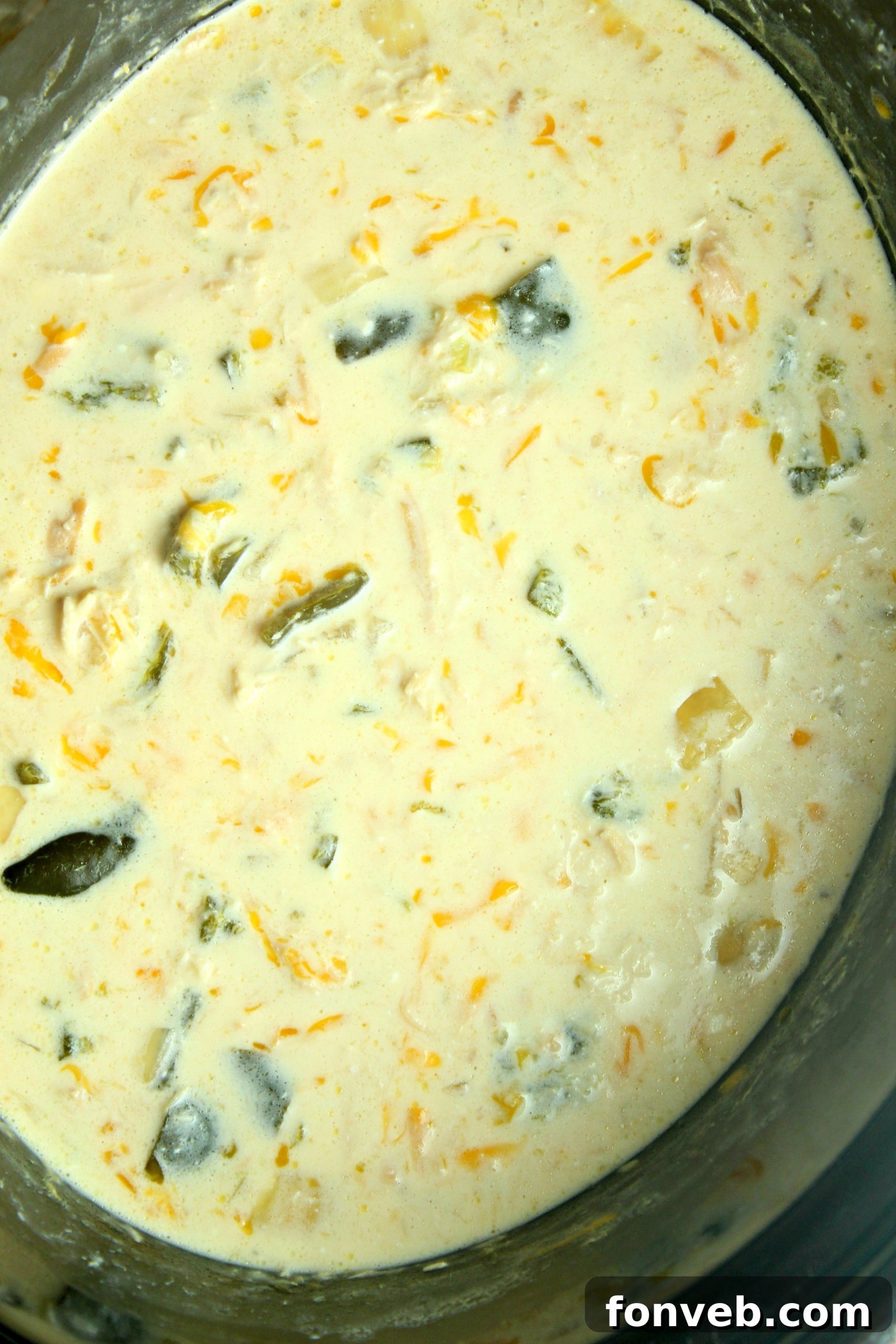 Overhead shot of Slow Cooker Chicken Chile Rellenos Soup in a bowl with tortilla chips