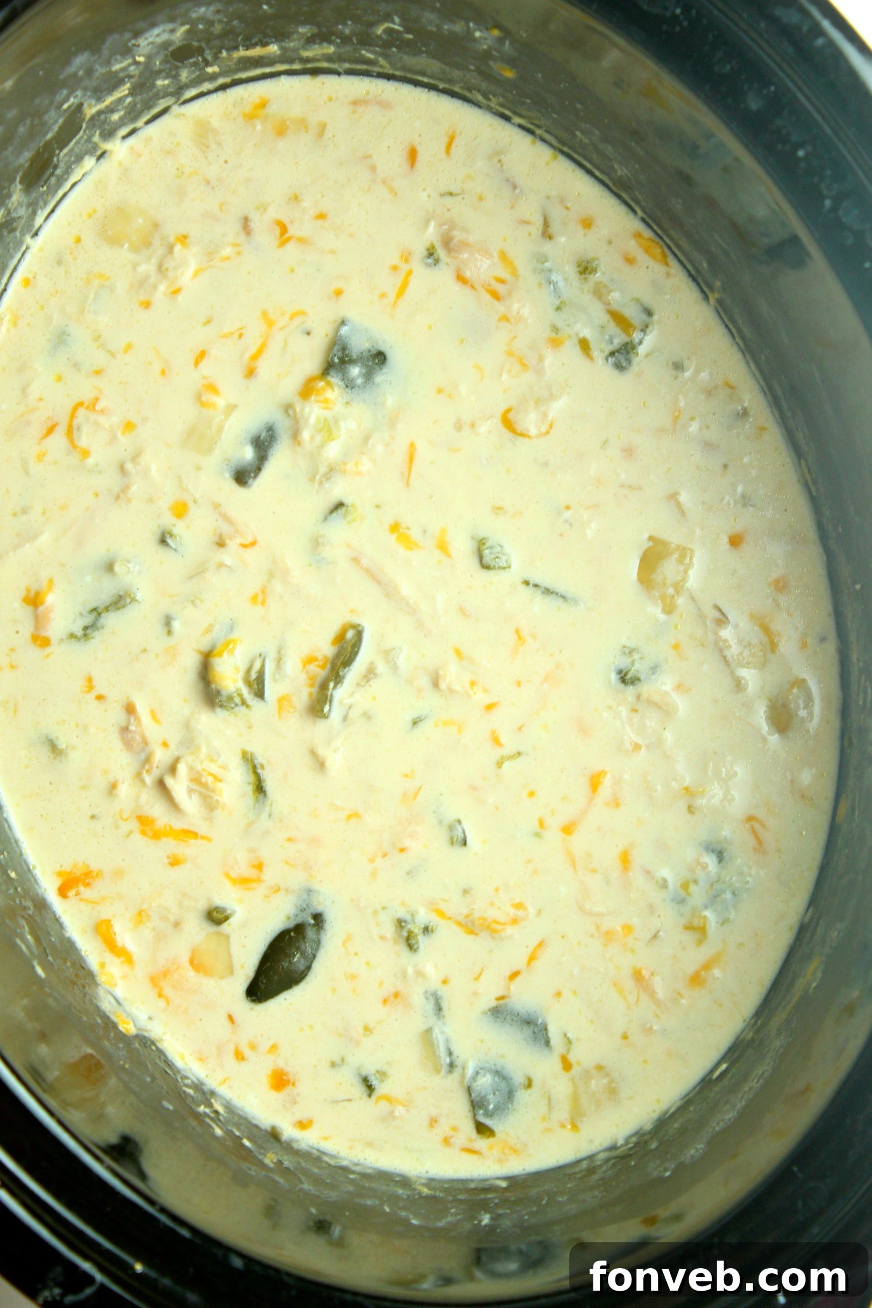 Full slow cooker pot filled with Chicken Chile Rellenos Soup