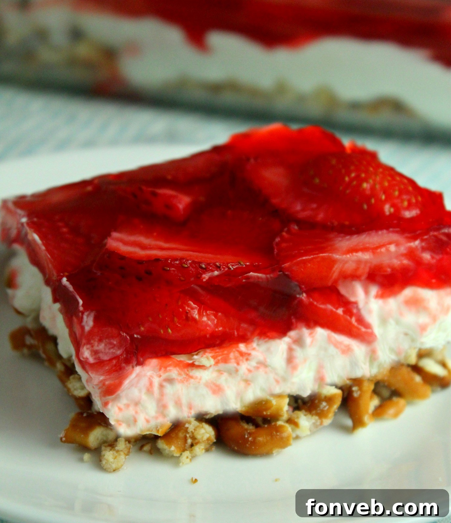 old image of my Strawberry Pretzel Salad on a white playe on a white table 