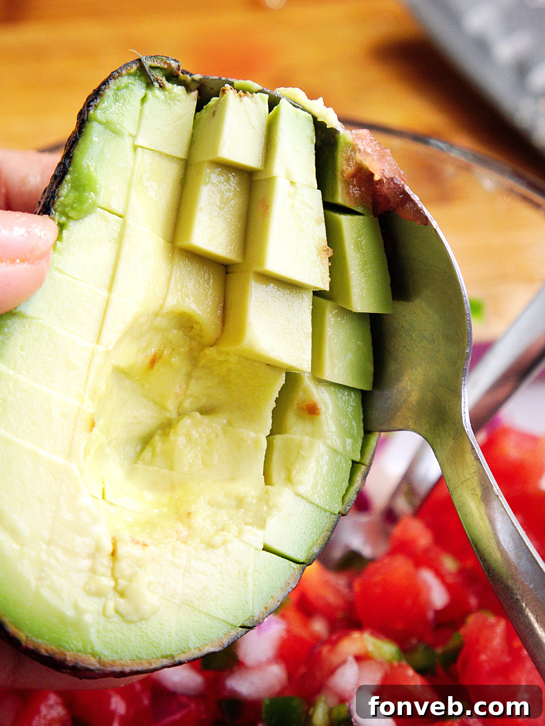 Various fresh ingredients laid out, including avocados, lime, and cilantro, ready for guacamole preparation.