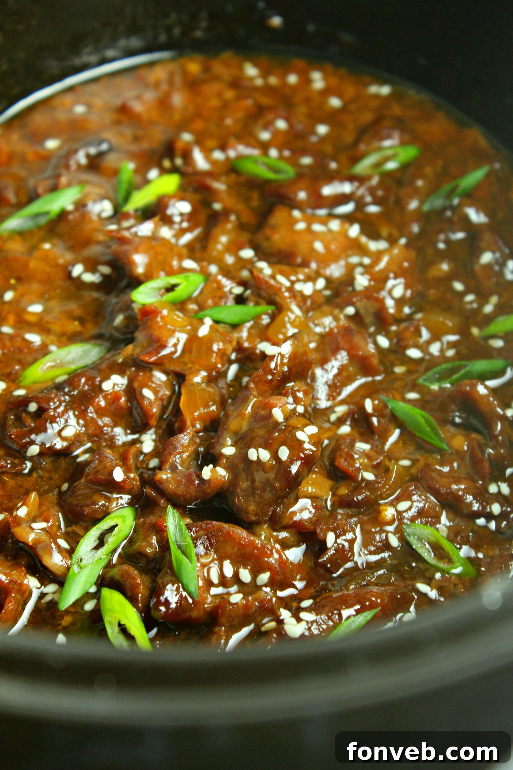 Slow Cooker Korean Beef in a dish with garnishes